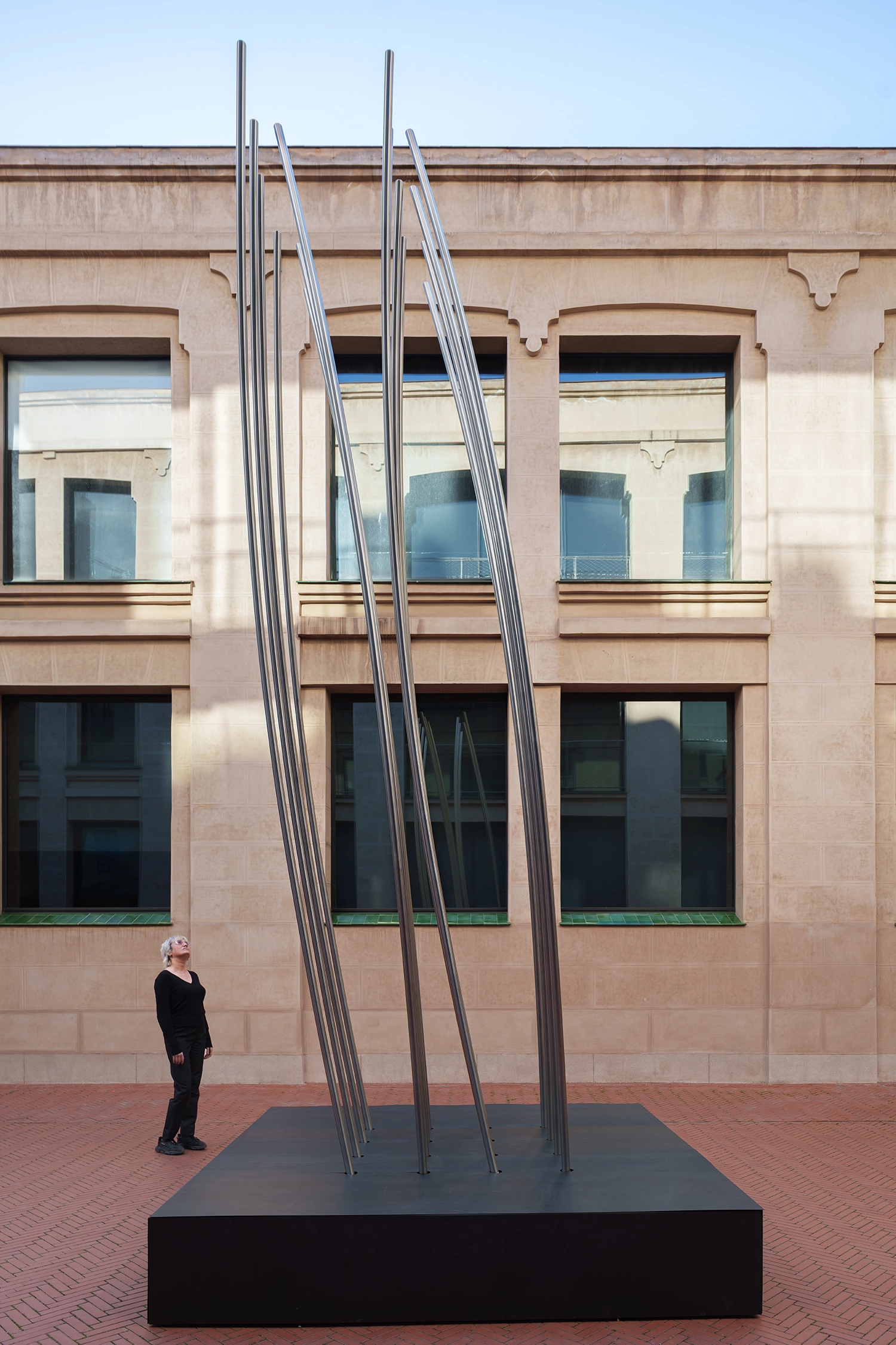 Low angle shot of the sixteen slats of DISLOCATION reaching toward the sky in Madrid.