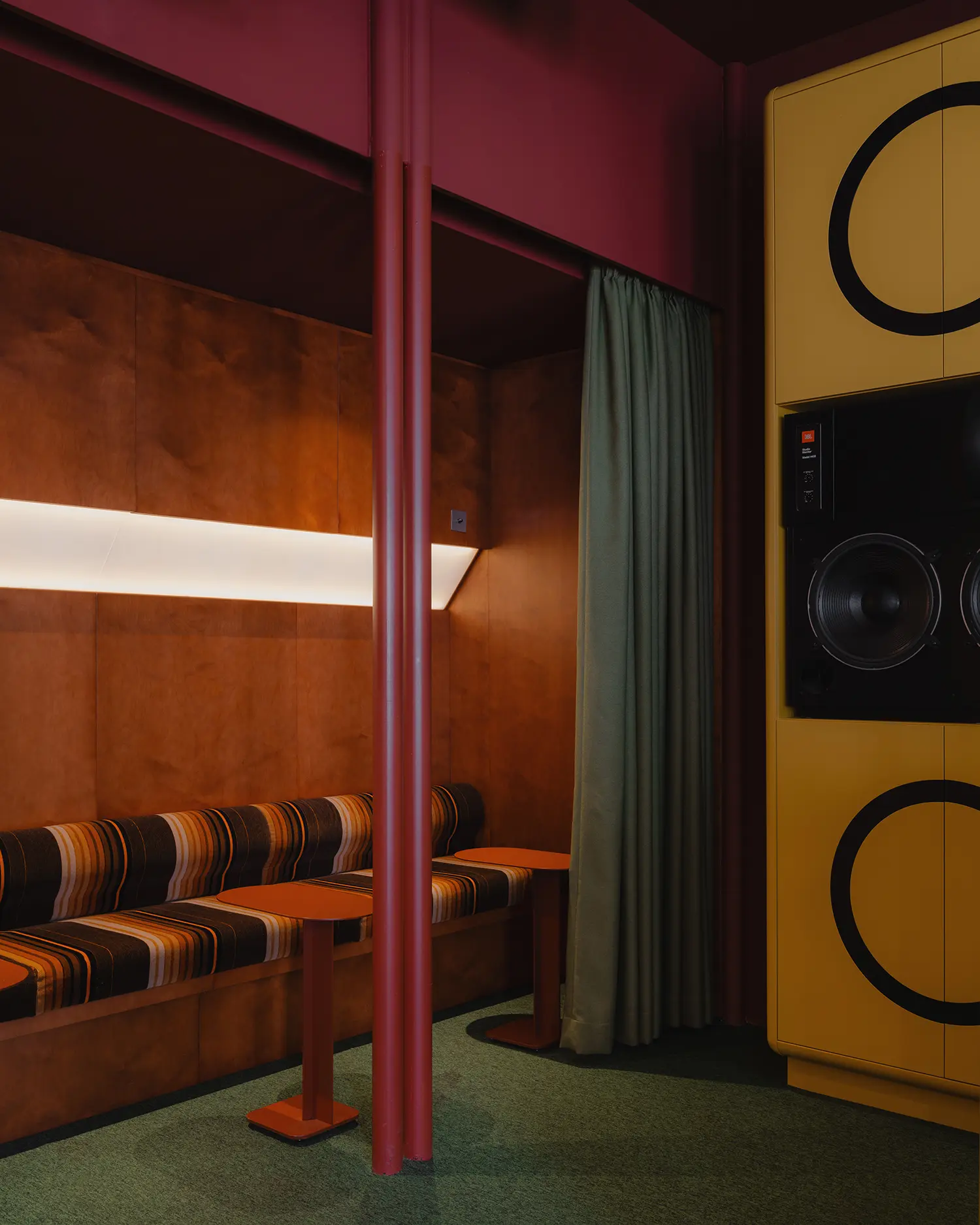 Cozy lounge compartment at EJE with wood paneling and striped upholstery.