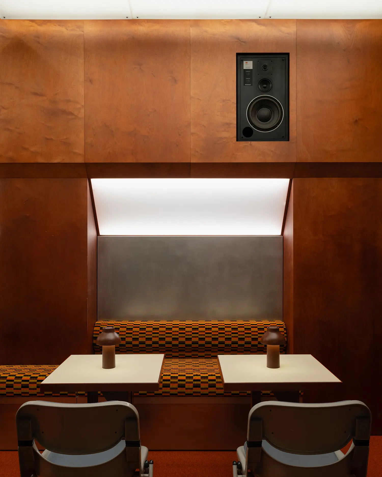 Symmetrical view of a seating module with integrated audio equipment.