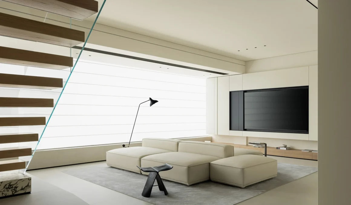Minimalist living room with modular off-white sofa and floating wooden staircase.