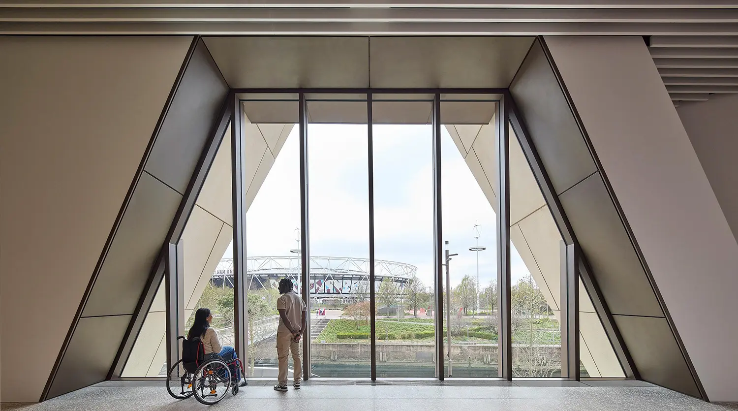 Large panoramic window inside V&A East Museum looking out toward the London Stadium.
