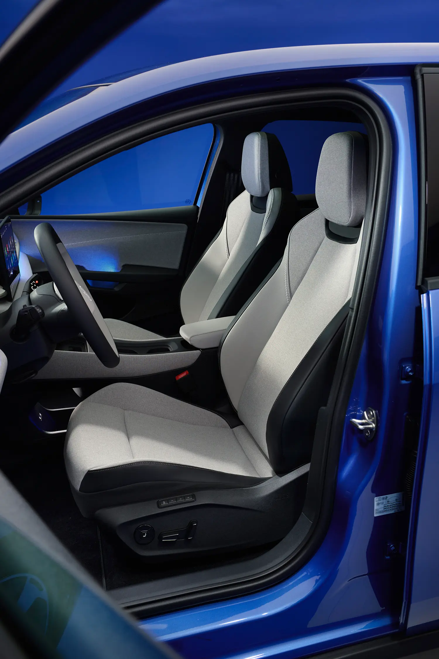 View of the front passenger and driver seats in light gray fabric.