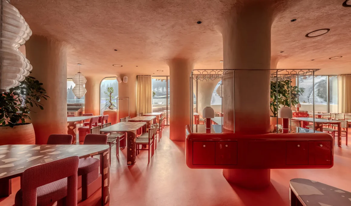 Interior of Rosso restaurant featuring biomorphic columns and a red-to-sandy gradient on the walls.