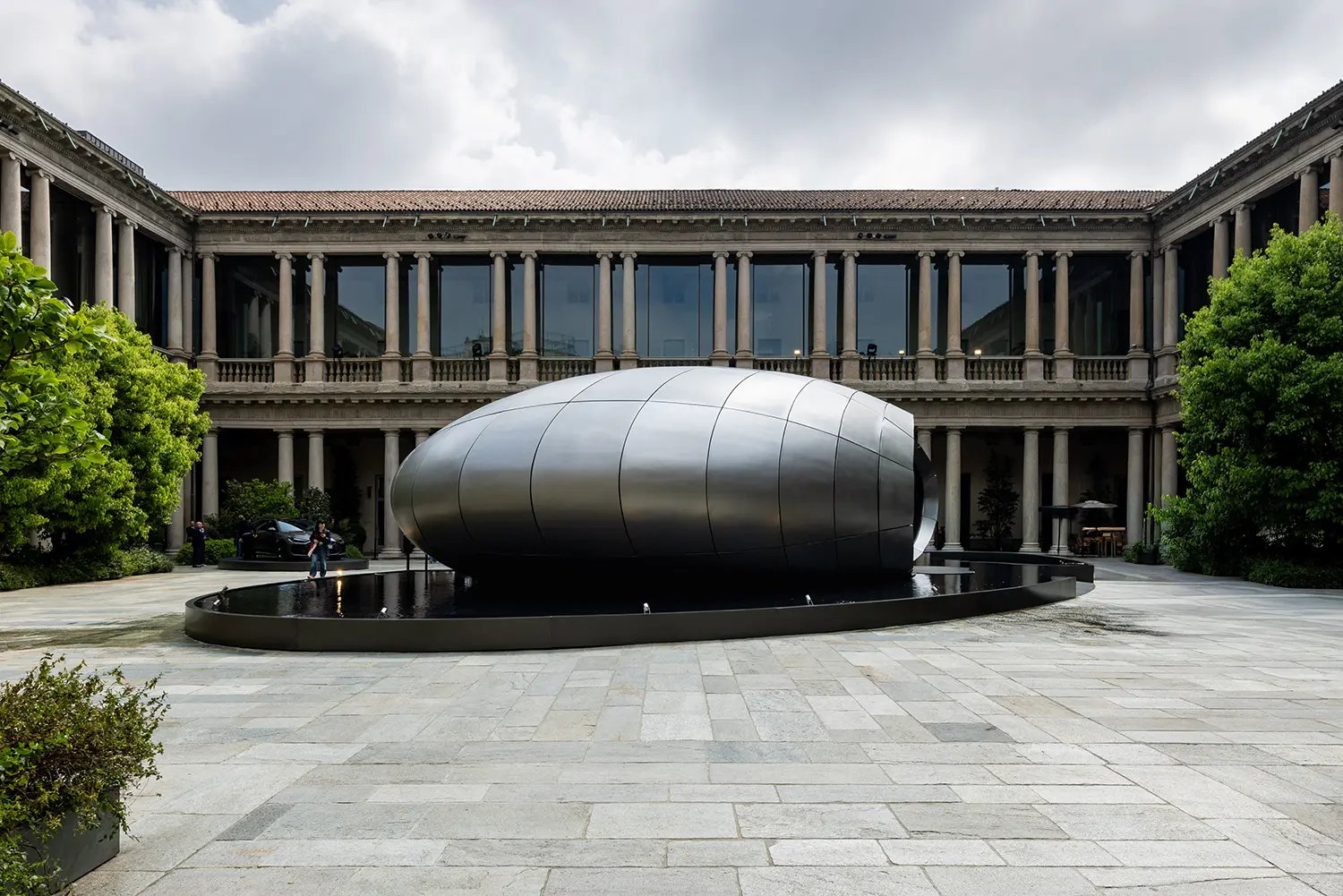 Wide shot of the Origin pavilion situated in the center of the historic Renaissance courtyard at Portrait Milano during Milan Design Week.
