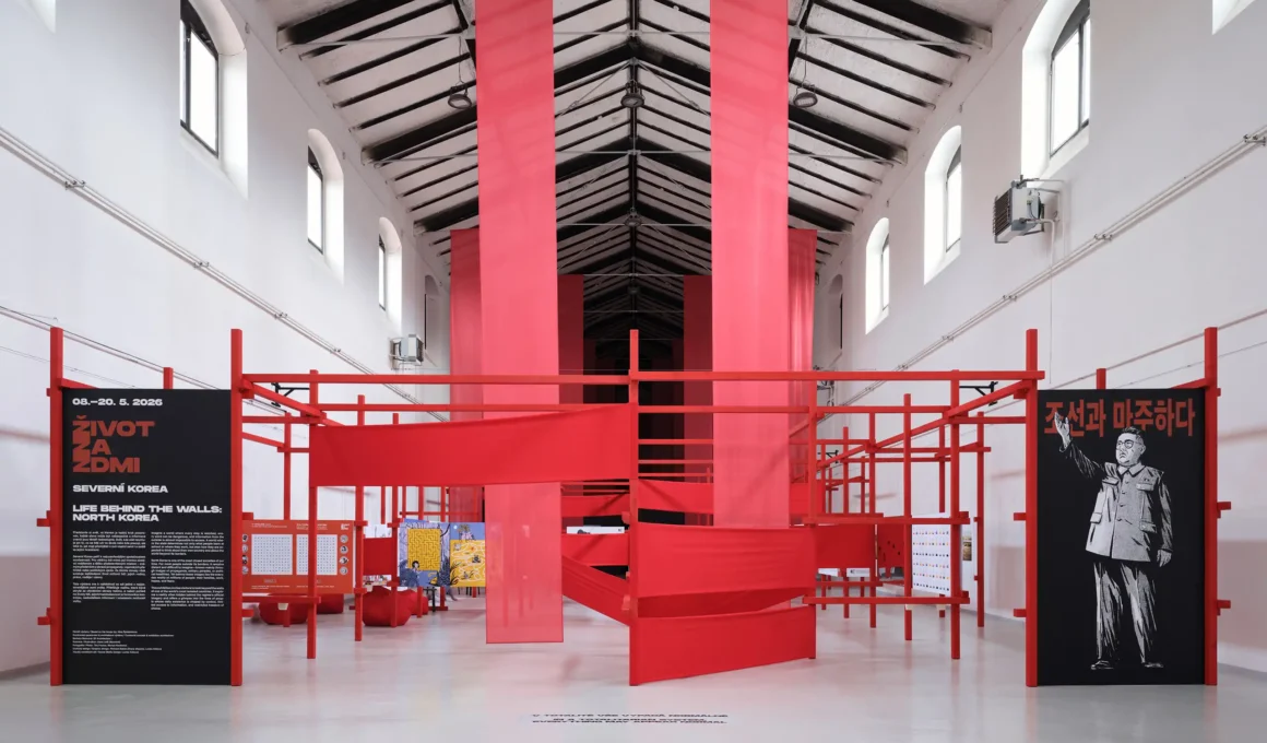 Life Behind the Walls B² Architecture Prague, red steel modular framework, stretched red textile walls, Kim Jong-un propaganda poster, Hall 13 Holešovice Market