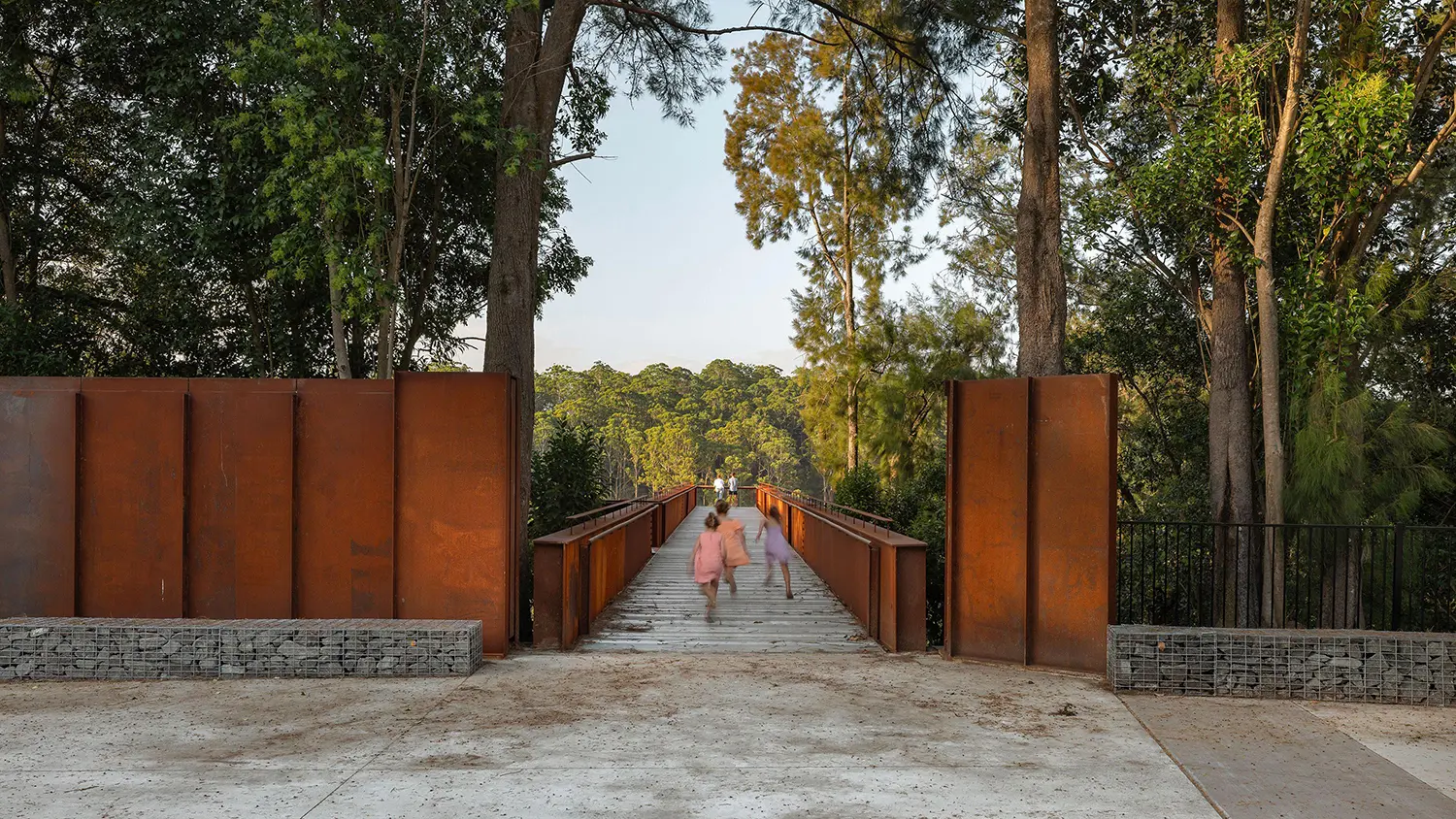 Entrance of the Southern Lookout framed by large vertical weathering steel plates and gabion stone walls.