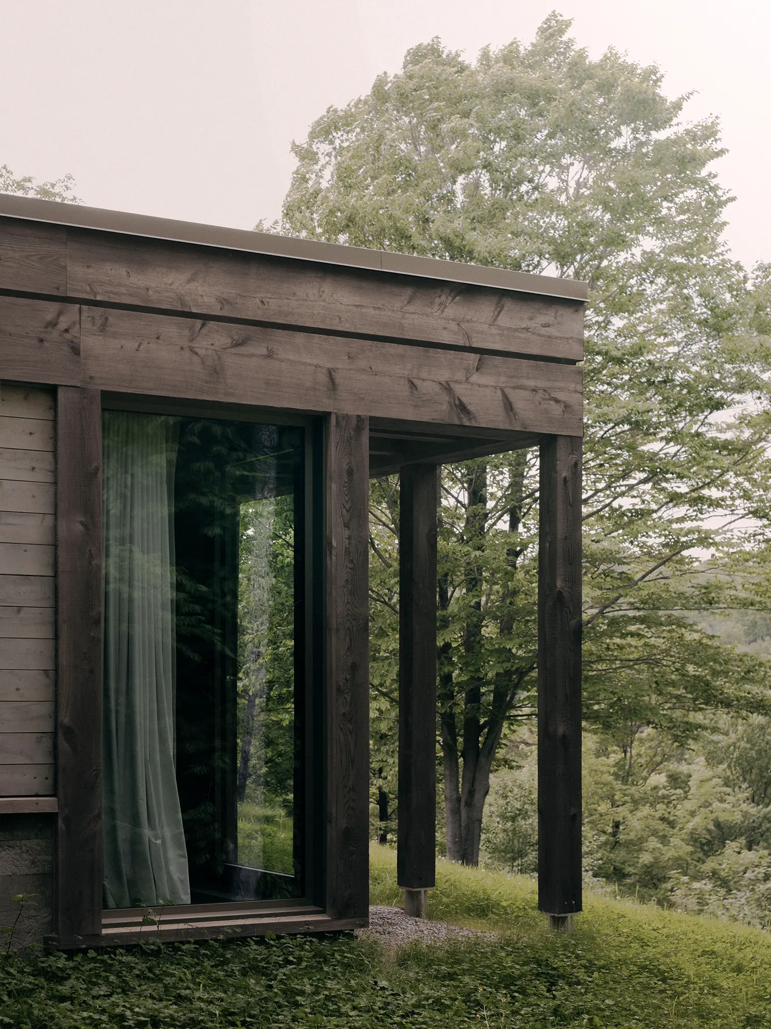 Atelier Carle SONO Residence reclaimed timber columns sliding glazed panels garden elevation detail Quebec 2025