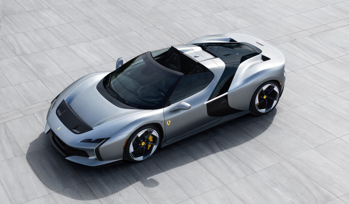 High-angle overview of the silver Ferrari HC25 one-off spider parked on a grey tiled outdoor plaza.