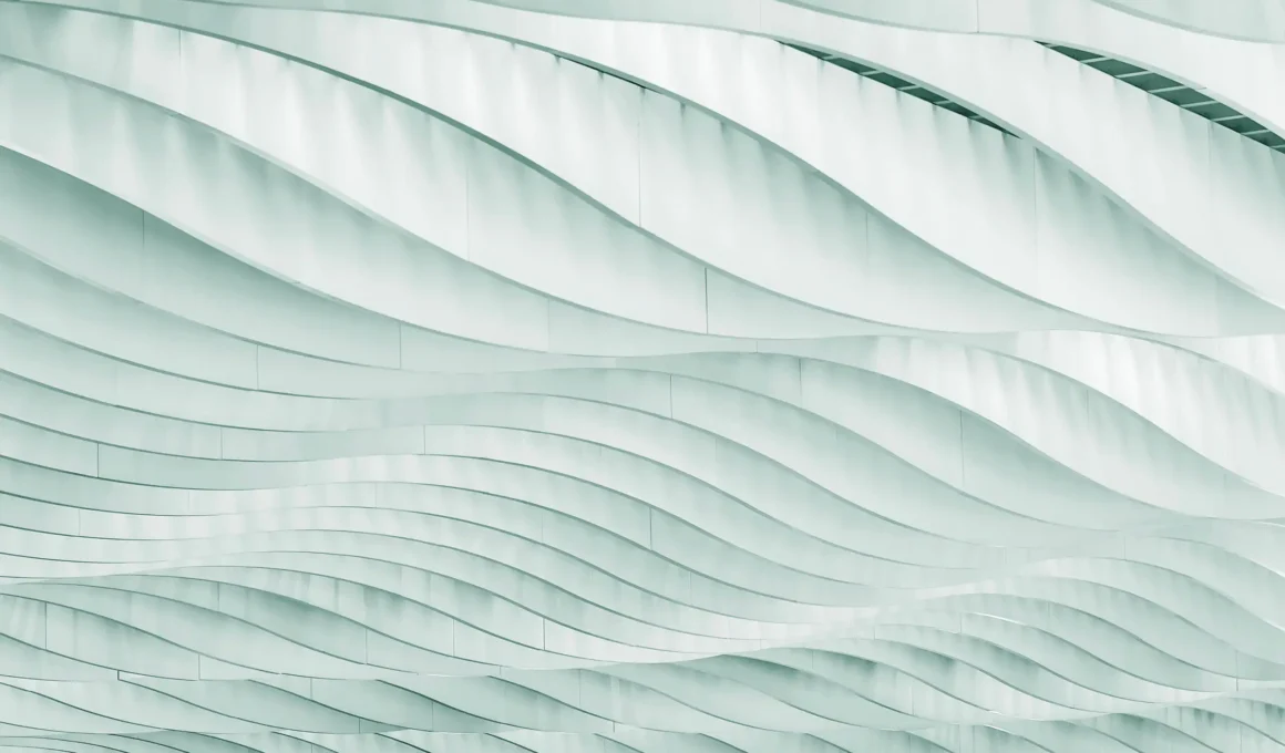 Modern architectural facade with curved white panels and wave pattern, industrial building exterior detail