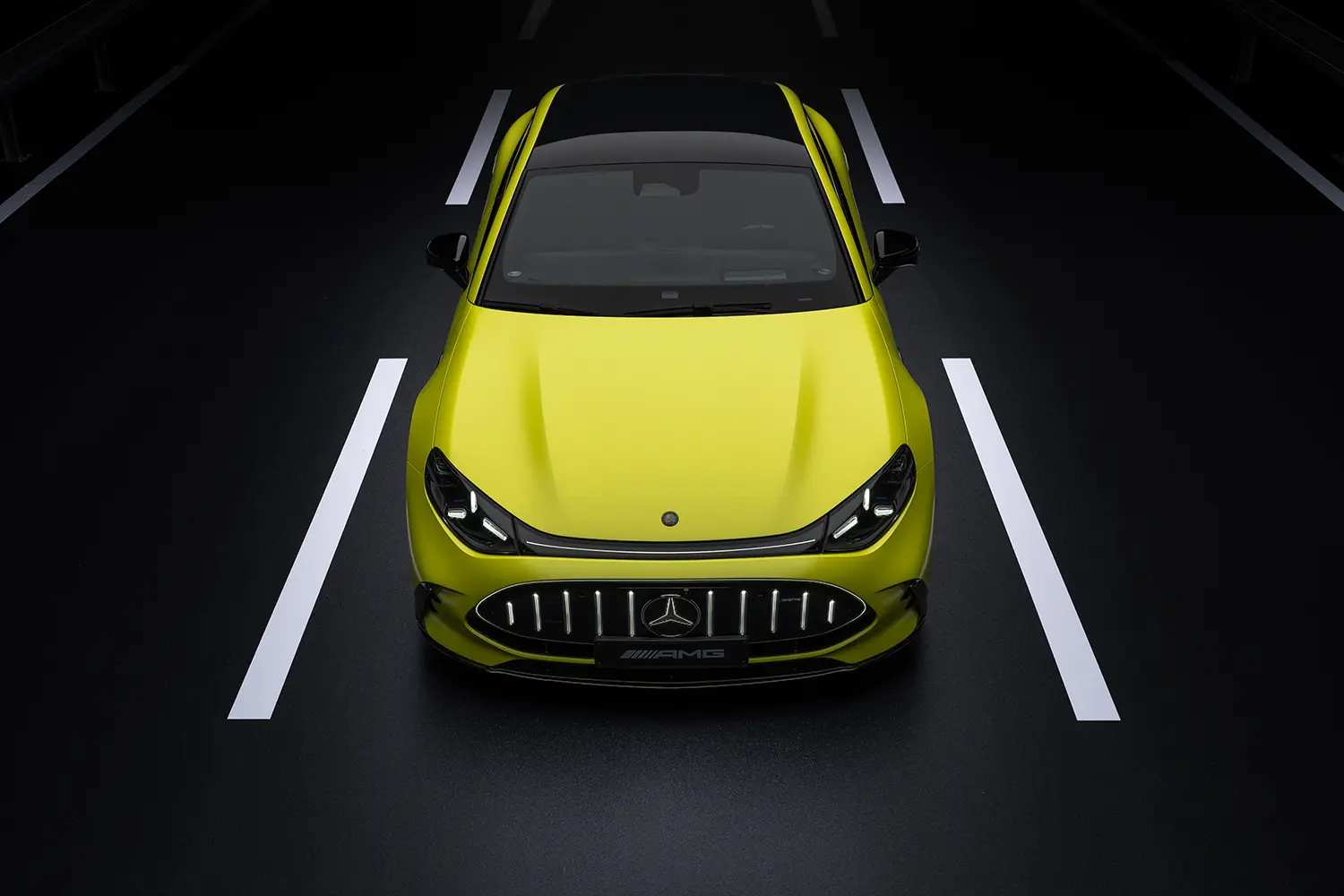Three-quarter front view of a copper-orange Mercedes-AMG GT sports car on a coastal road during dusk.