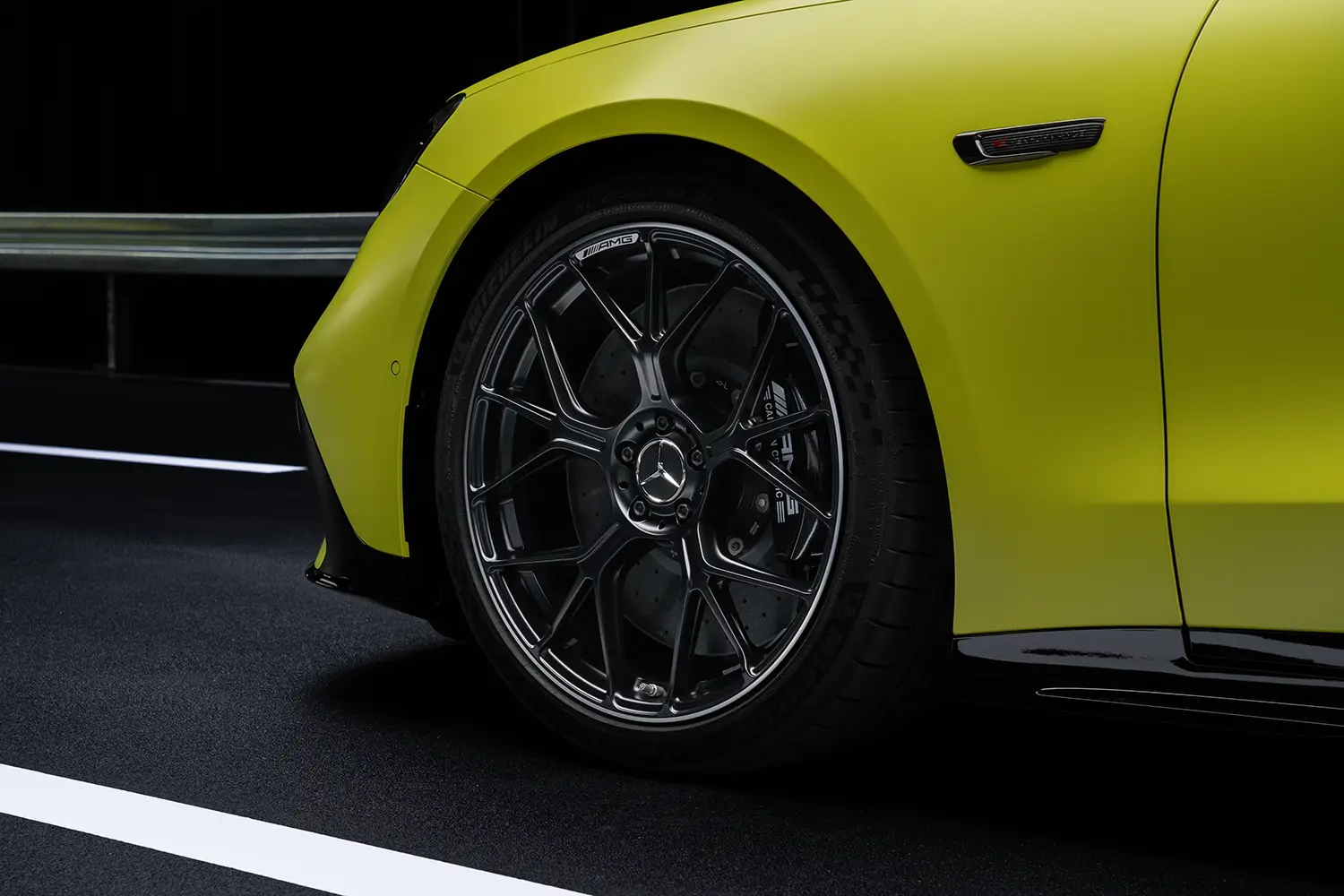 Close-up of a multi-spoke alloy wheel with bronze brake calipers on a copper-orange Mercedes-AMG vehicle.