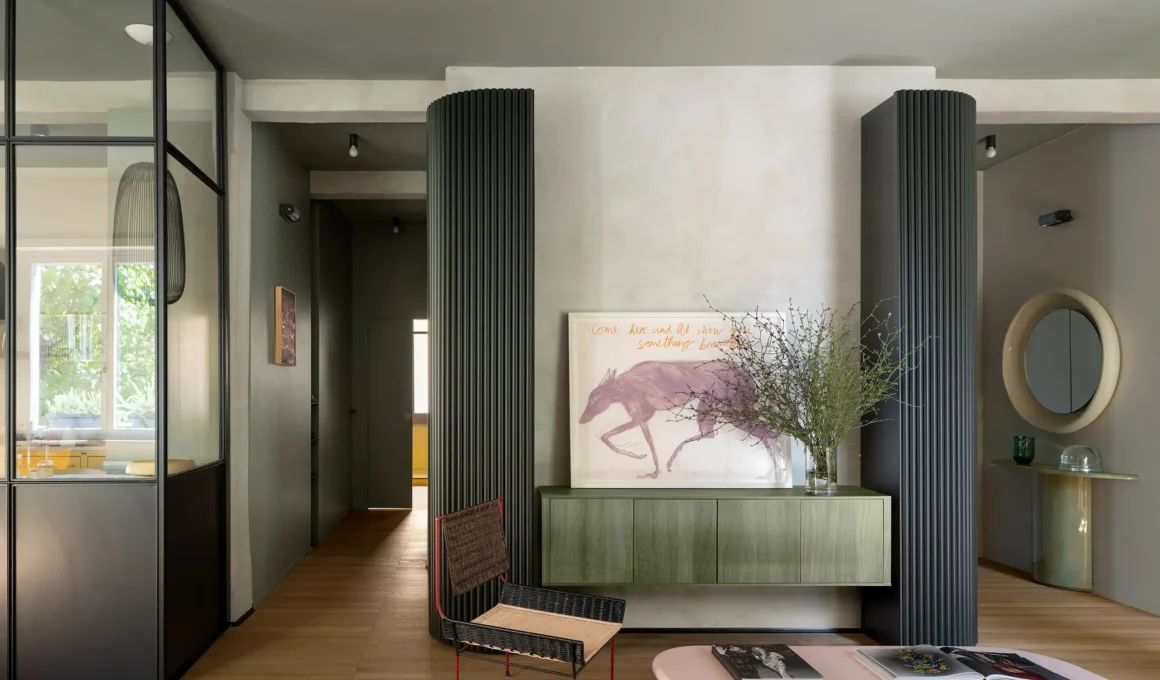 Casa Harmonía Rome by Punto Zero, black rounded slat boiserie volume, green wood sideboard, French-style glazed kitchen partition, oak parquet