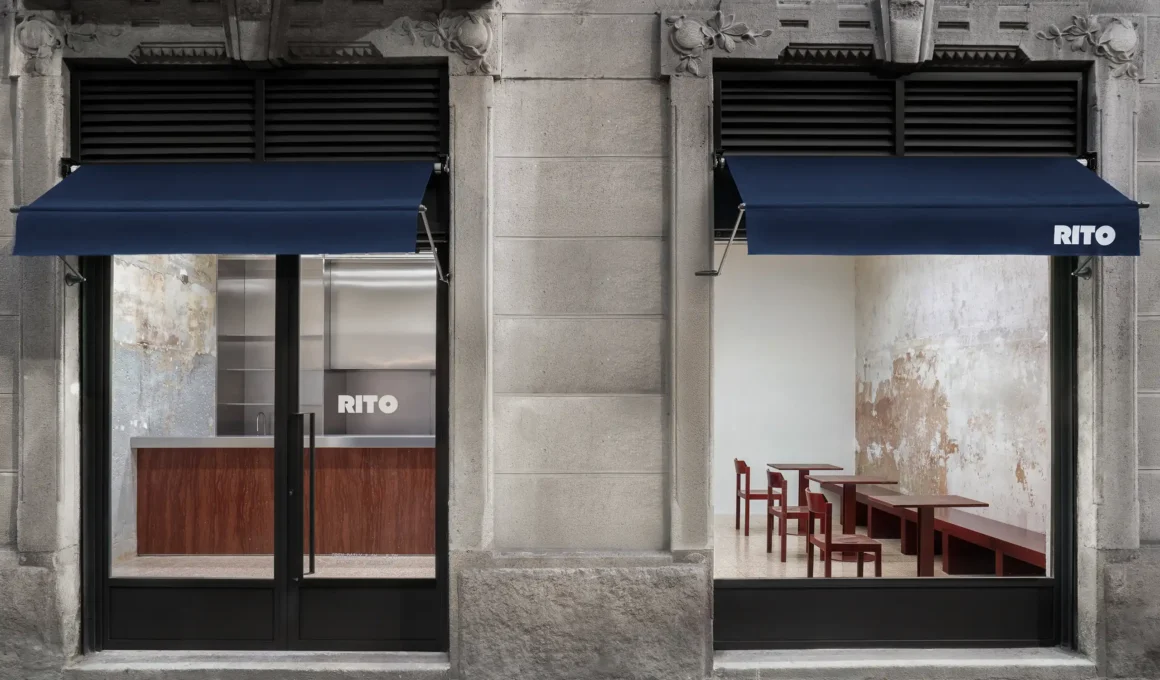 Exterior view of Bar Rito in Milan showing two storefront windows with blue awnings and original stone facade.