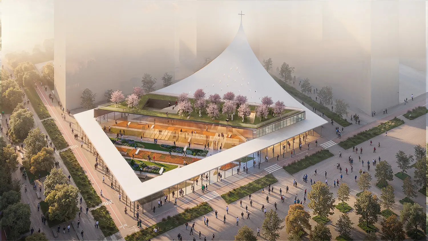 Aerial view of a triangular architectural complex with a central green courtyard and a rooftop garden with pink trees.