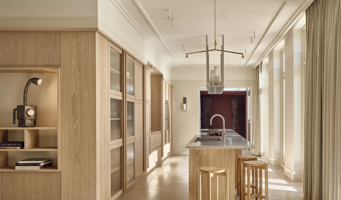 Studio Modijefsky kitchen with oak island, stainless steel countertop, textured glass cabinets and travertine floor, Home Wilhelminalaan