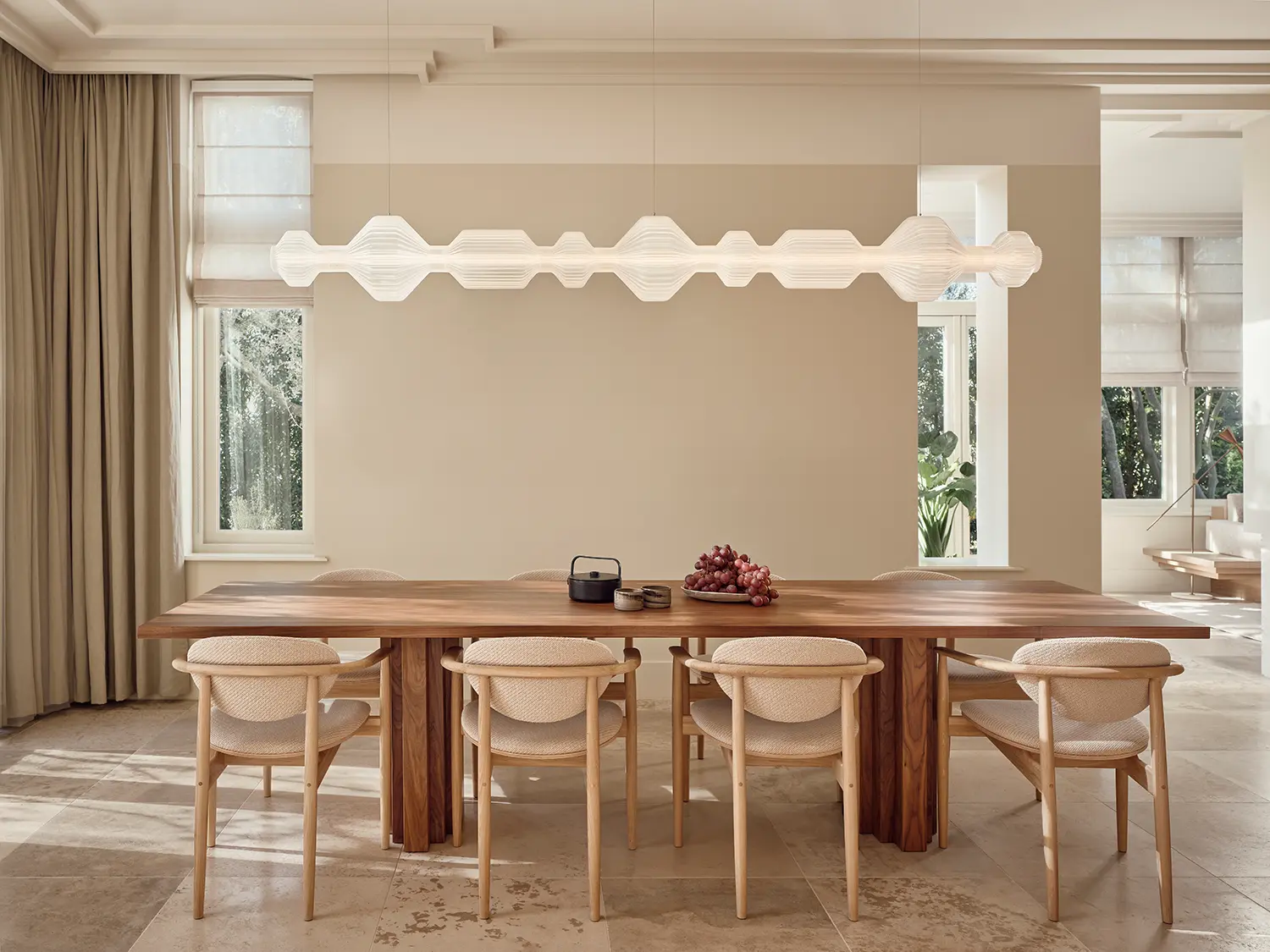Dining room with dark walnut table, oak chairs, white modular pendant light and travertine floor, Home Wilhelminalaan Netherlands