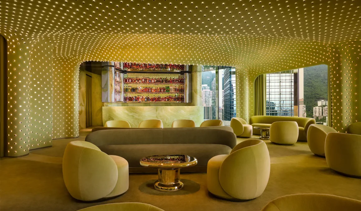 Interior view of Peridot bar in Hong Kong featuring a seamless green plaster ceiling with a grid of glowing light points and plush velvet seating.