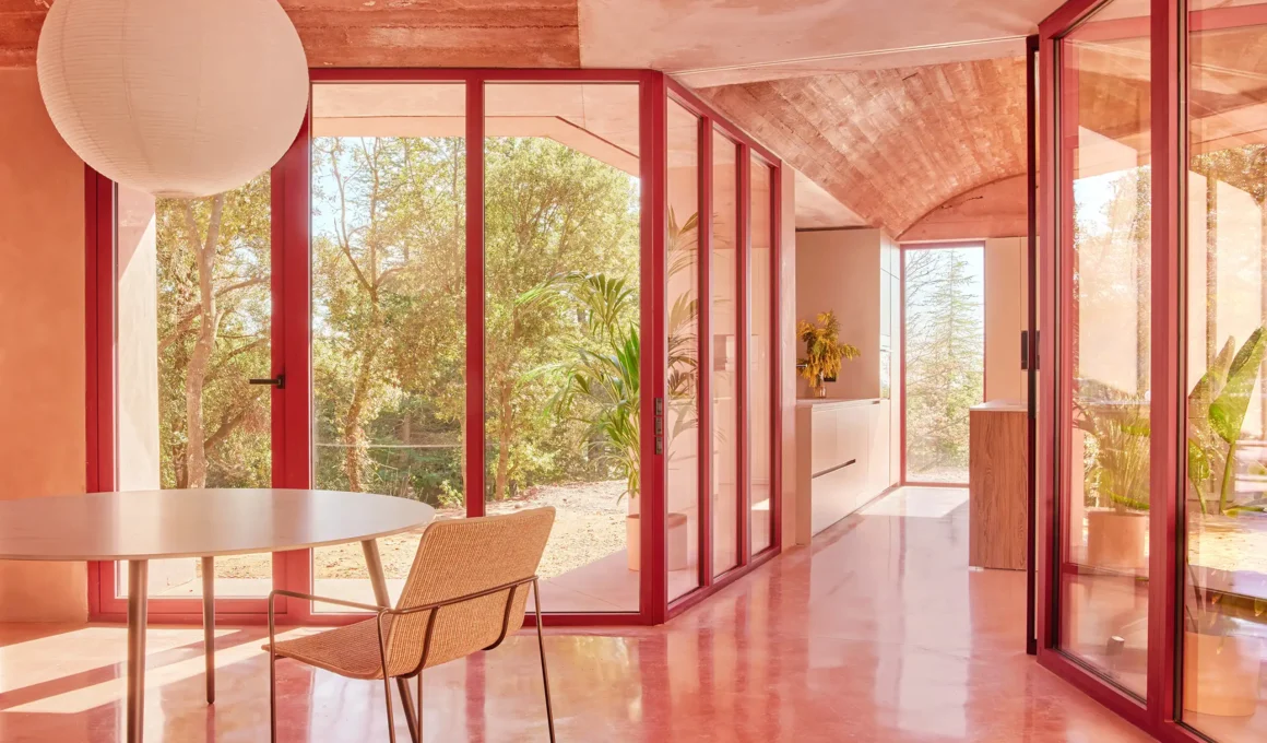 Casa Sota la Mola by Twobo, pigmented concrete volta catalana interior with red-framed glazing, Matadepera