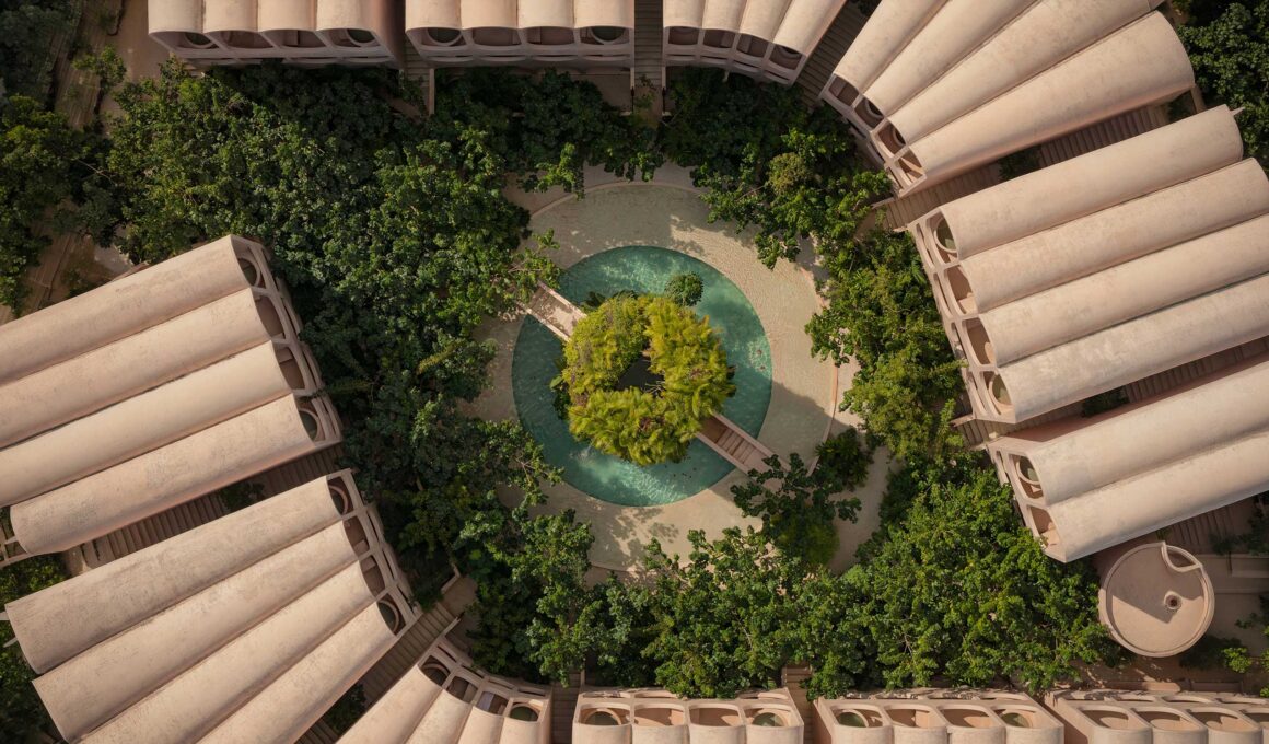Aerial bird's-eye view of Babel's eye-shaped floor plan with a central jungle courtyard and circular pool.