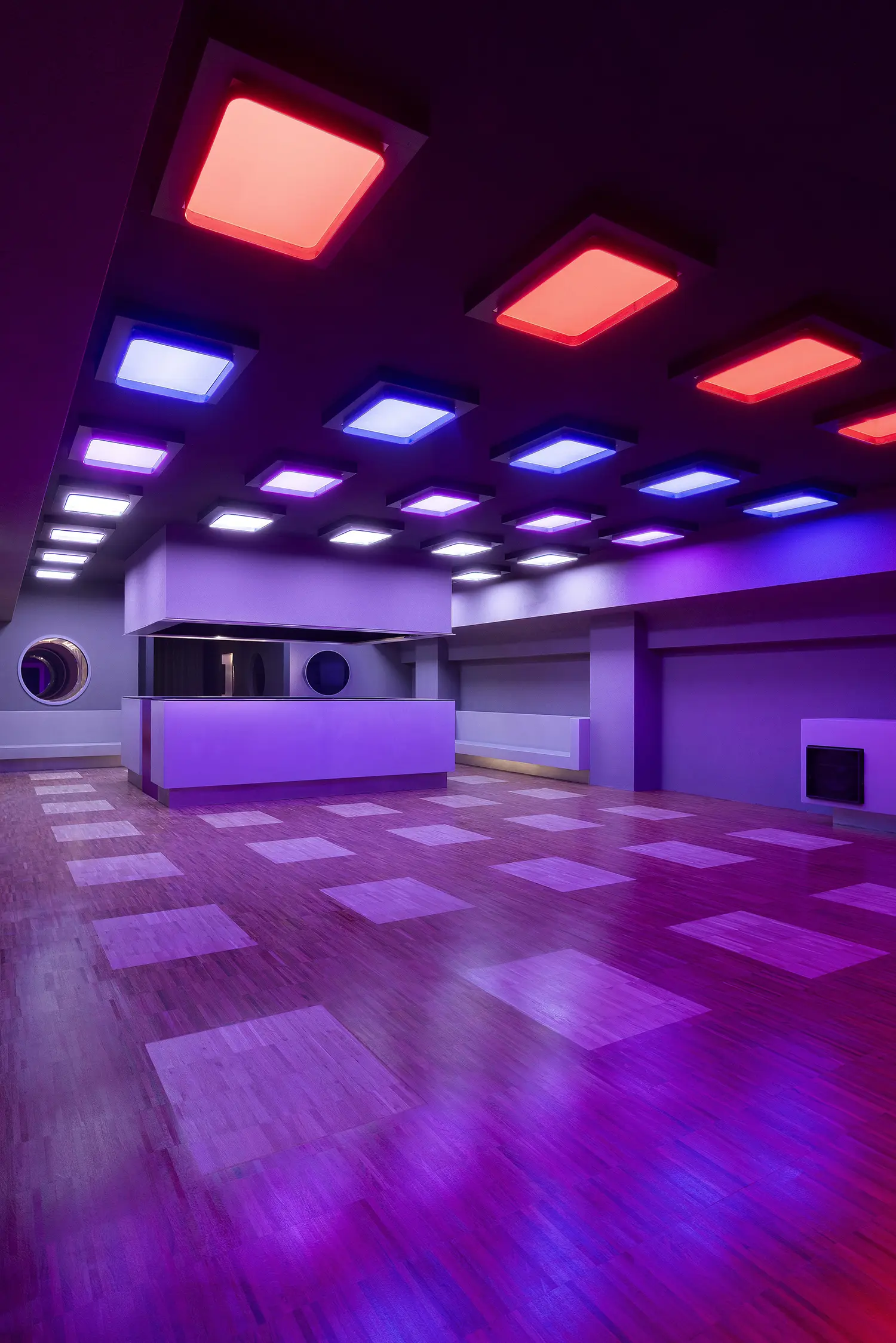 DURO club Milan Velvet Studio, main dancefloor with LED ceiling panels in red and blue, parquet floor, command bar in center