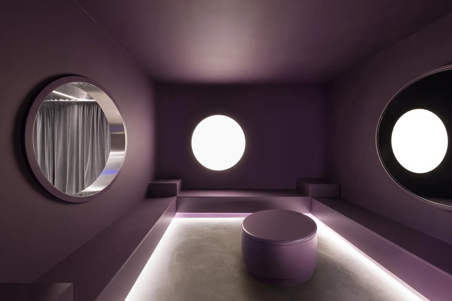 DURO club Milan Velvet Studio, purple relax room with three circular portholes, concrete floor, low seating platform, ambient lighting