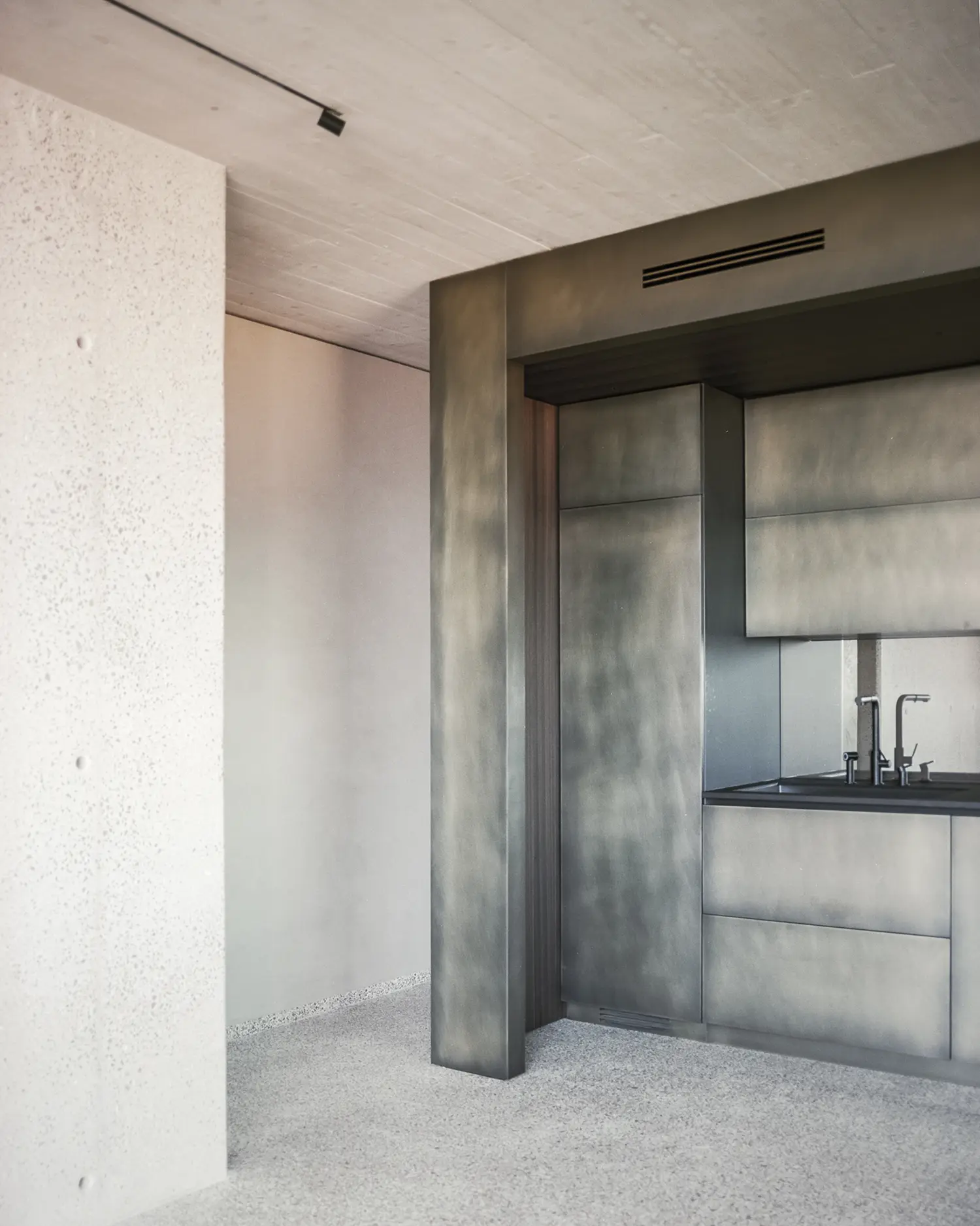 Villa S-2113 Calvi Ceschia Viganò, bush-hammered concrete wall, burnished metal kitchen joinery, Genoese terrazzo floor, exposed ceiling