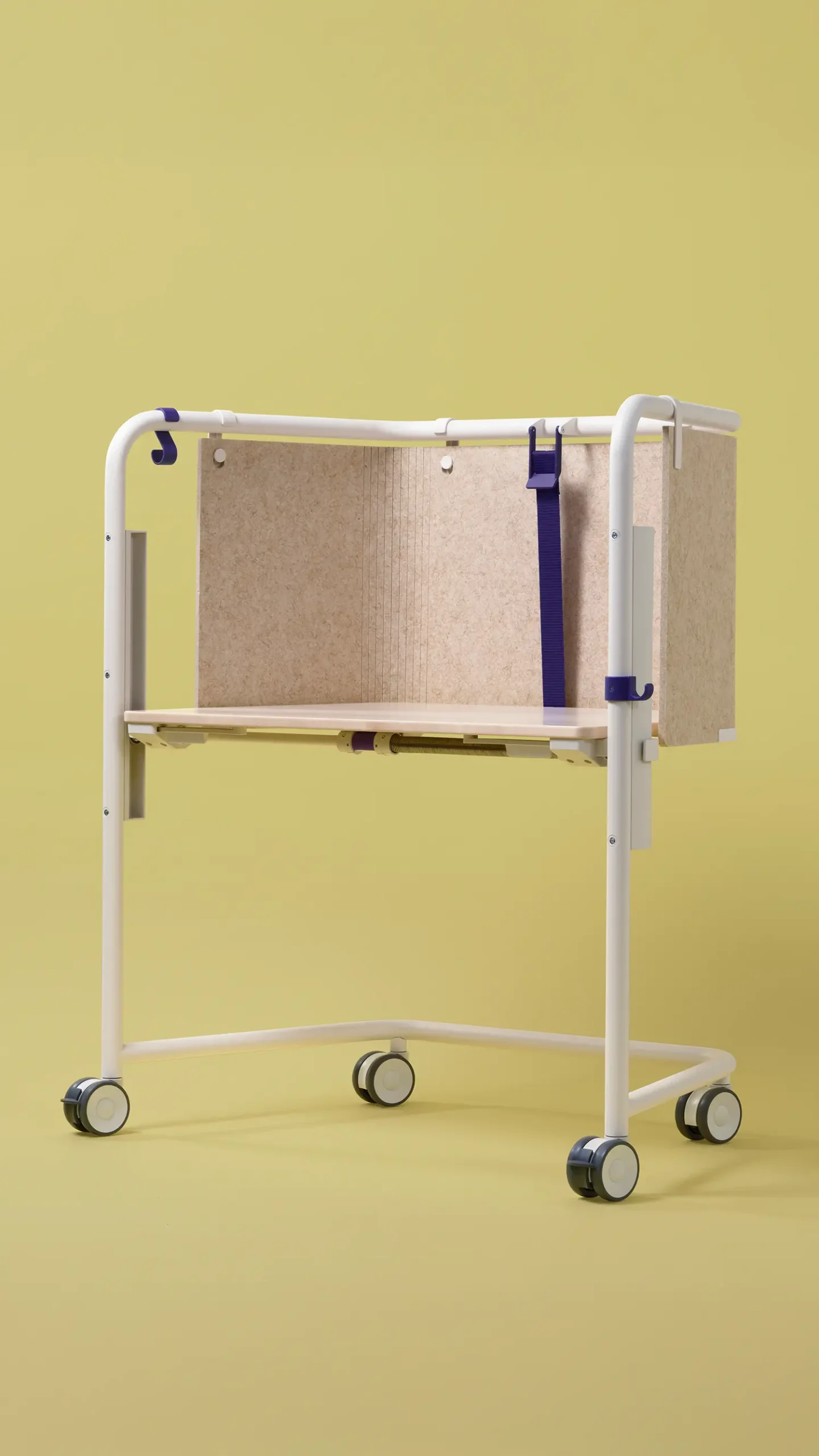 Profile view of a white Scout mobile desk with height-adjustment mechanics visible beneath the top.