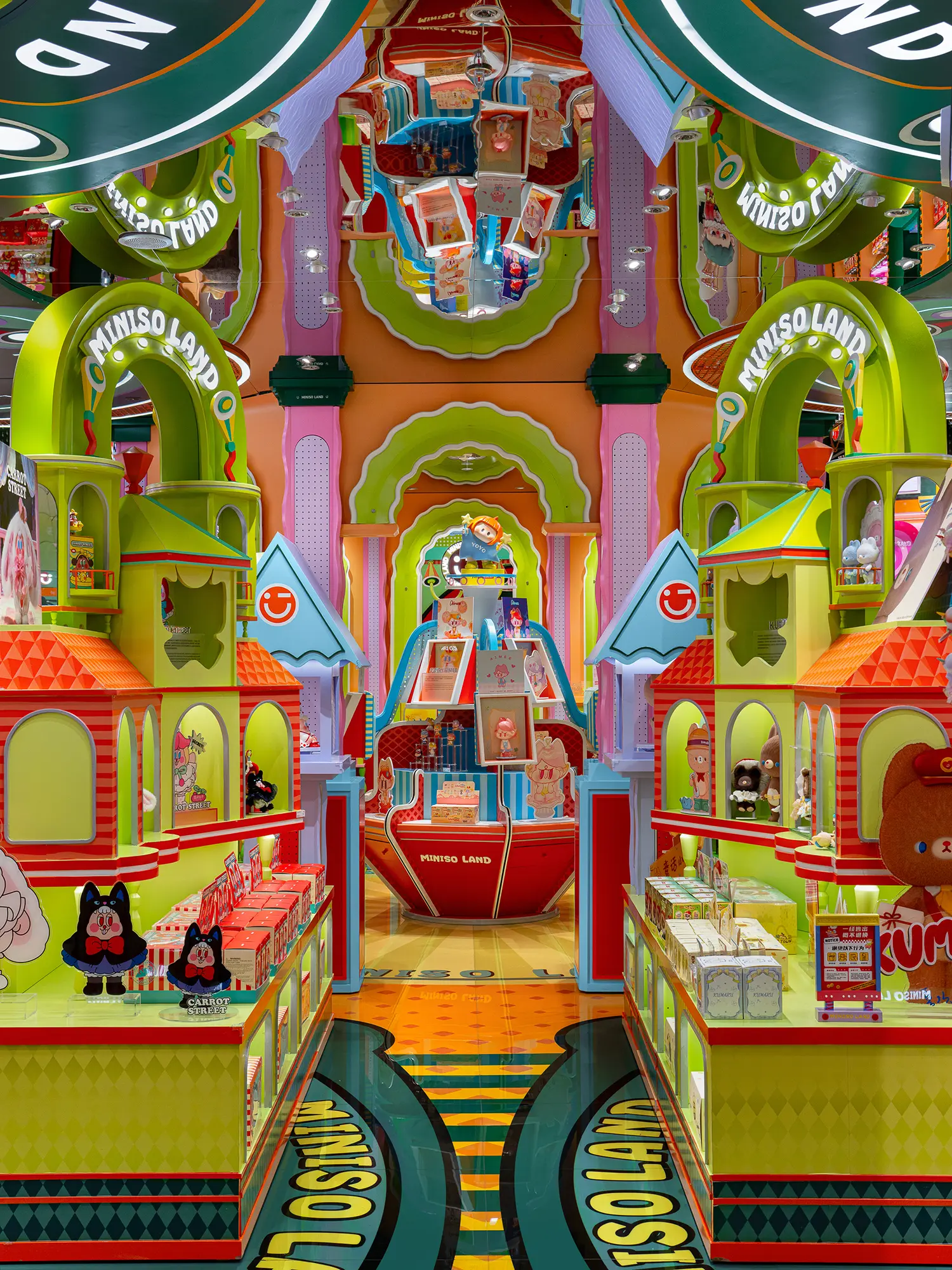 Bright green and orange symmetrical toy display aisles with mirrored ceiling at MINISO LAND.