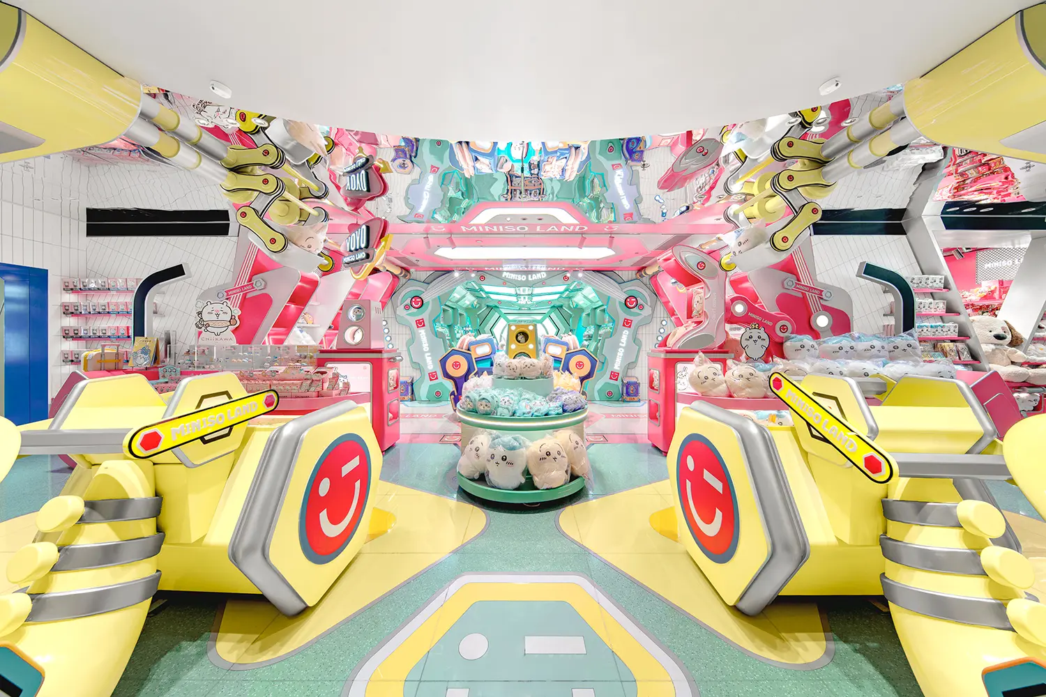 Bright futuristic pink and yellow second-floor interior of MINISO LAND Guangzhou store.