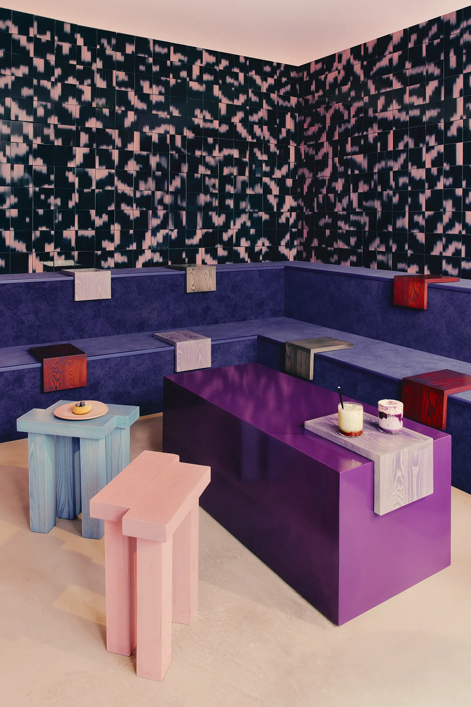 Café Shin Marais Uchronia Paris screening room Palet ikat tiles navy pink purple upholstered platform wood stools