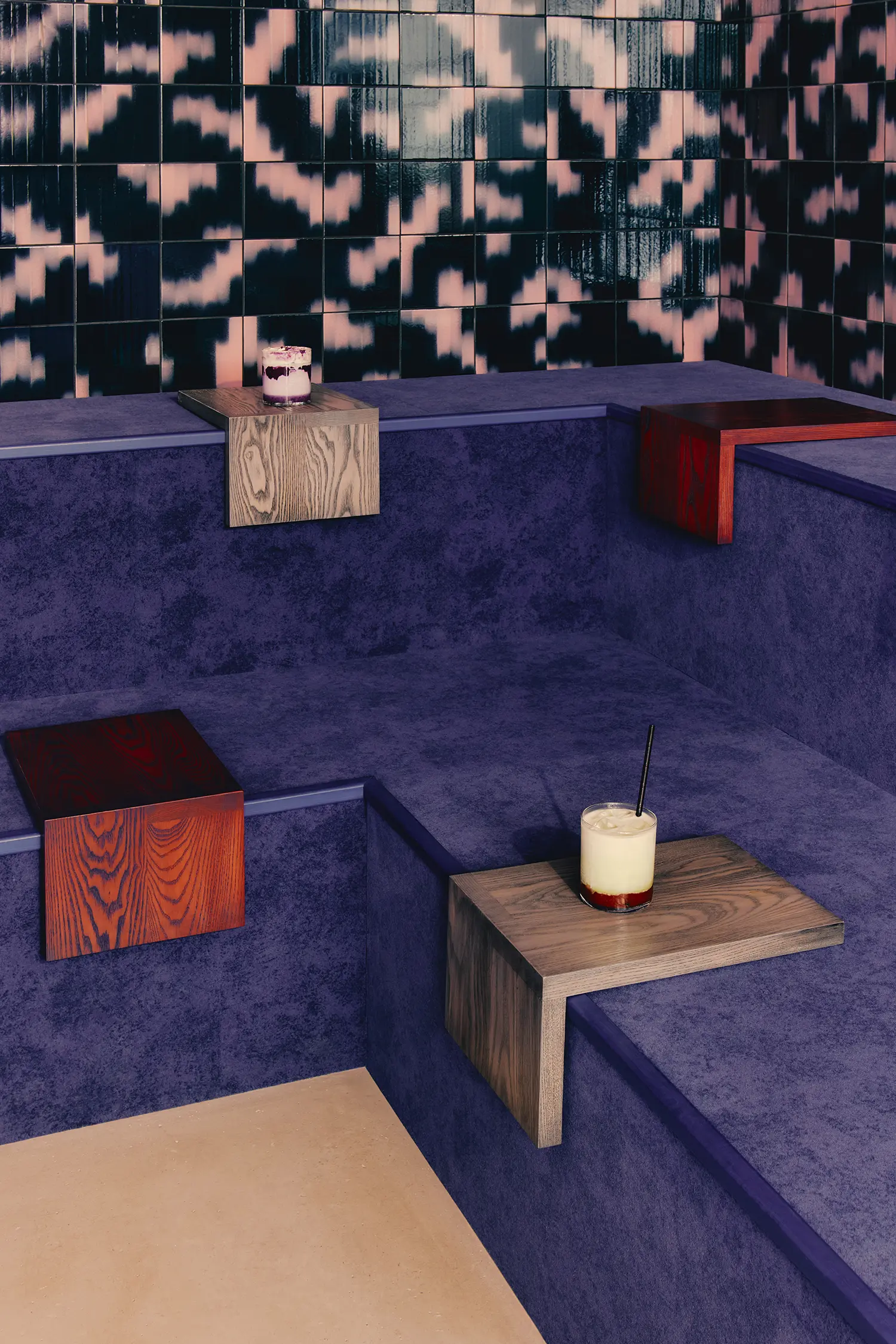 Café Shin Marais Uchronia Paris screening room purple velvet platform stained wood side tables Palet ikat tiles detail