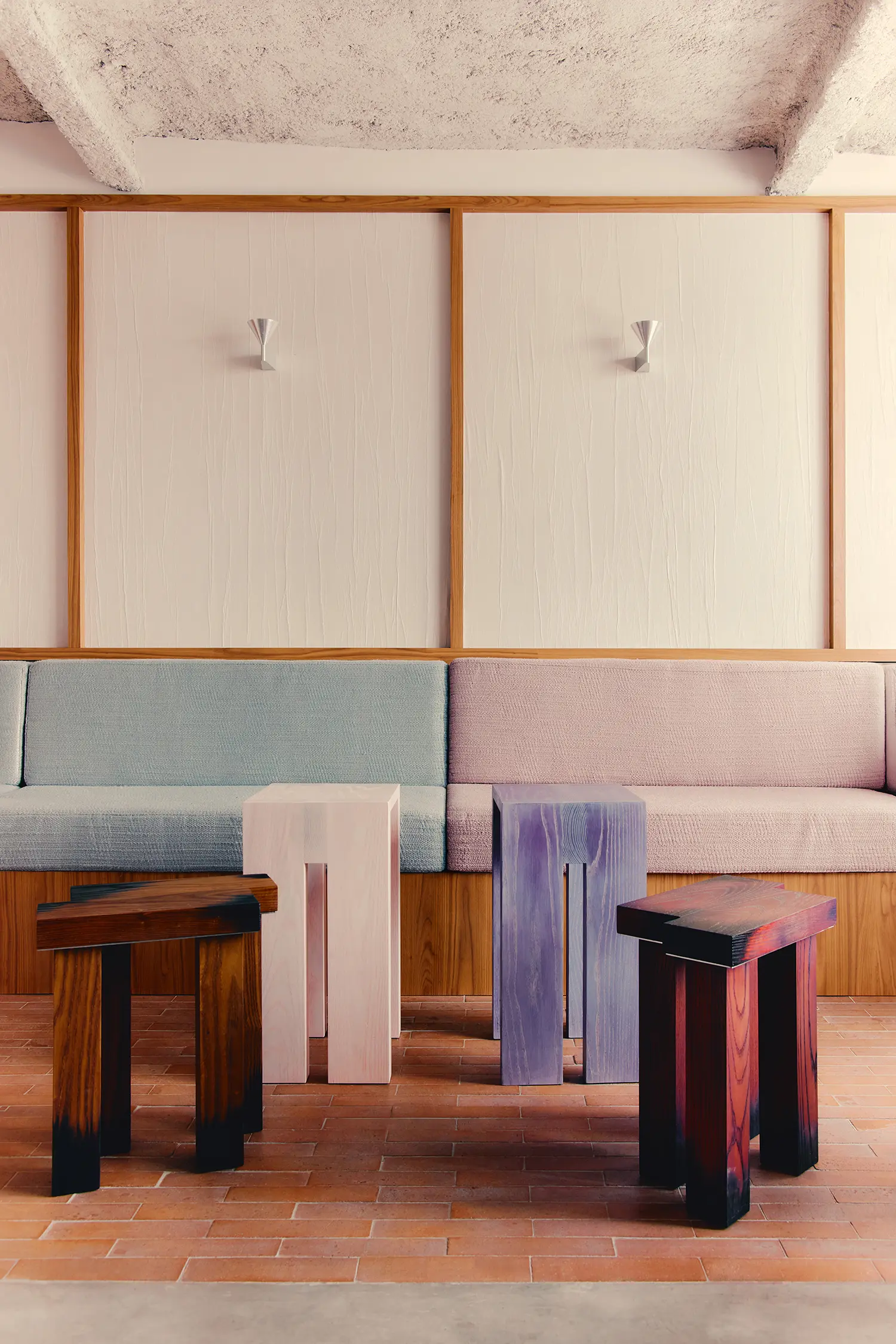 Café Shin Marais Uchronia Paris bench seating pale blue pink upholstery oak paneling terracotta tile floor stained wood stools