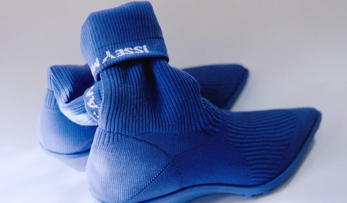 Camper x Issey Miyake Anna boot in blue TENCEL knit, rear view showing folded cuff with woven Issey Miyake logo