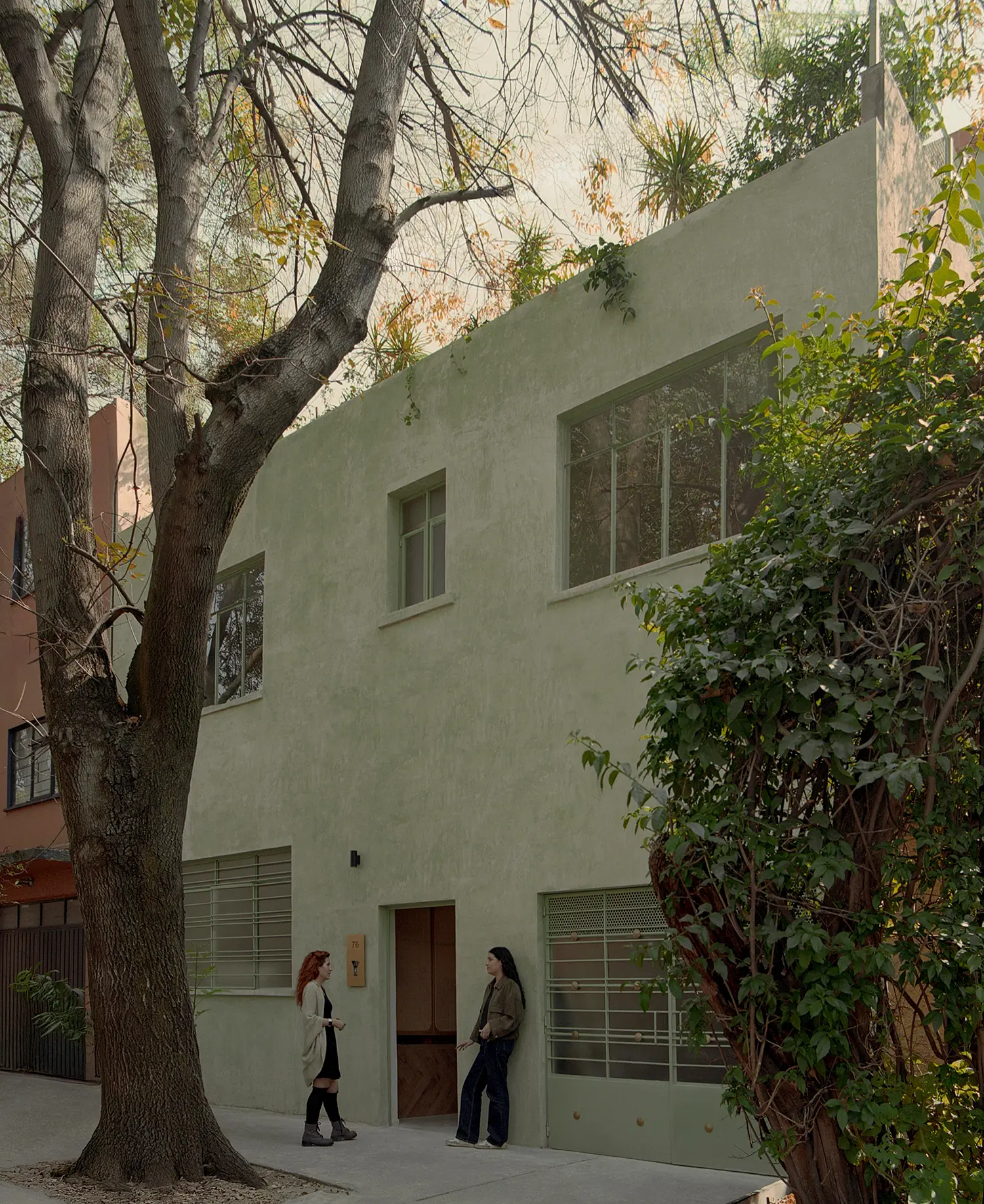 Casa Xoltic AMASA Estudio, two-storey exterior façade with mineral plaster finish, restored ironwork grilles, Colonia Del Carmen Coyoacán