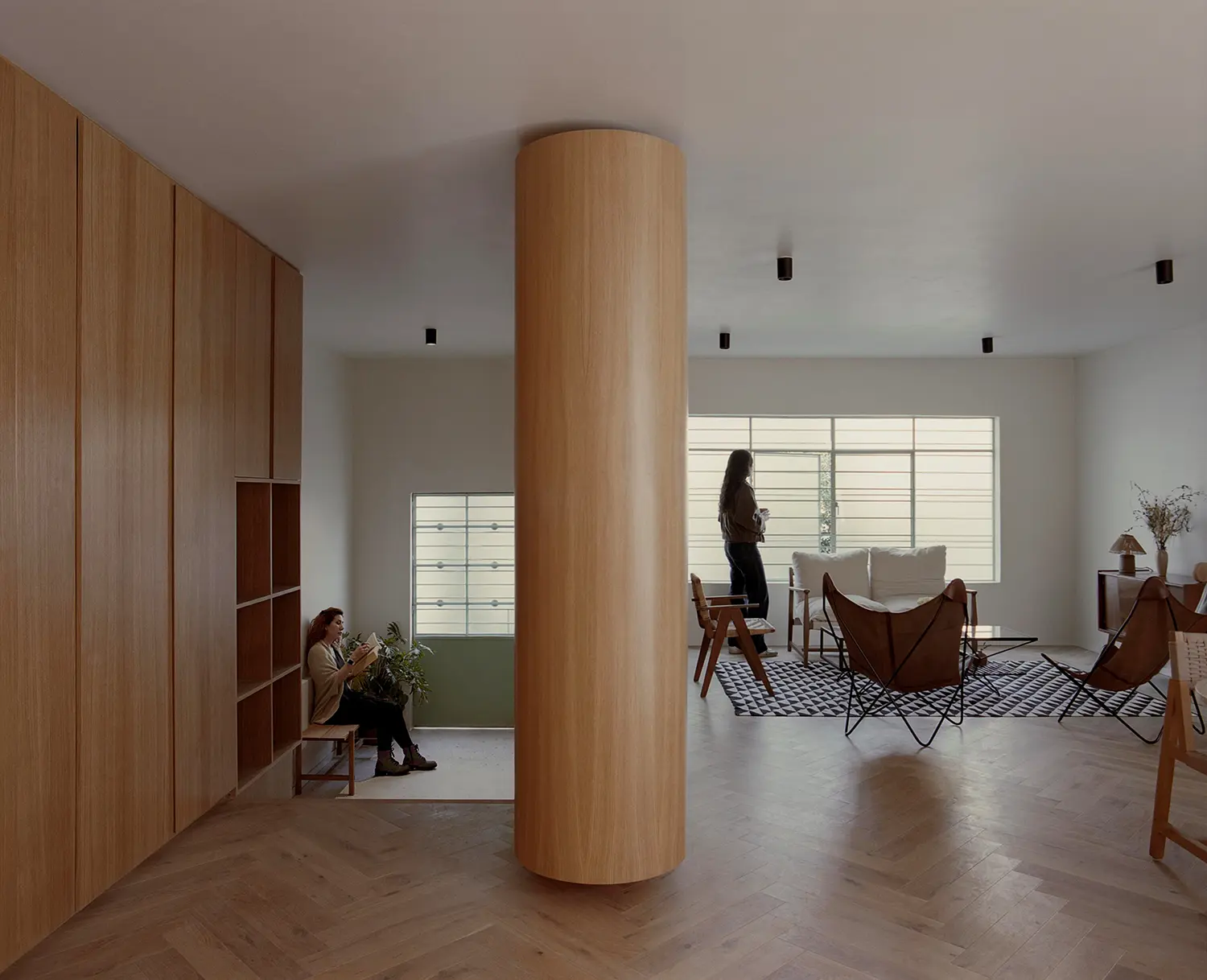 Casa Xoltic AMASA Estudio, ground floor interior with custom wood millwork wall, cylindrical clad column, herringbone parquet floor, Coyoacán