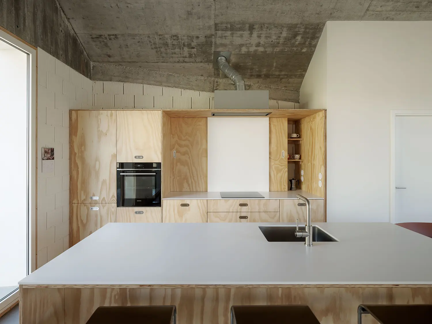 Cecebre House Sinaldaba Galicia kitchen plywood cabinetry exposed concrete ceiling island