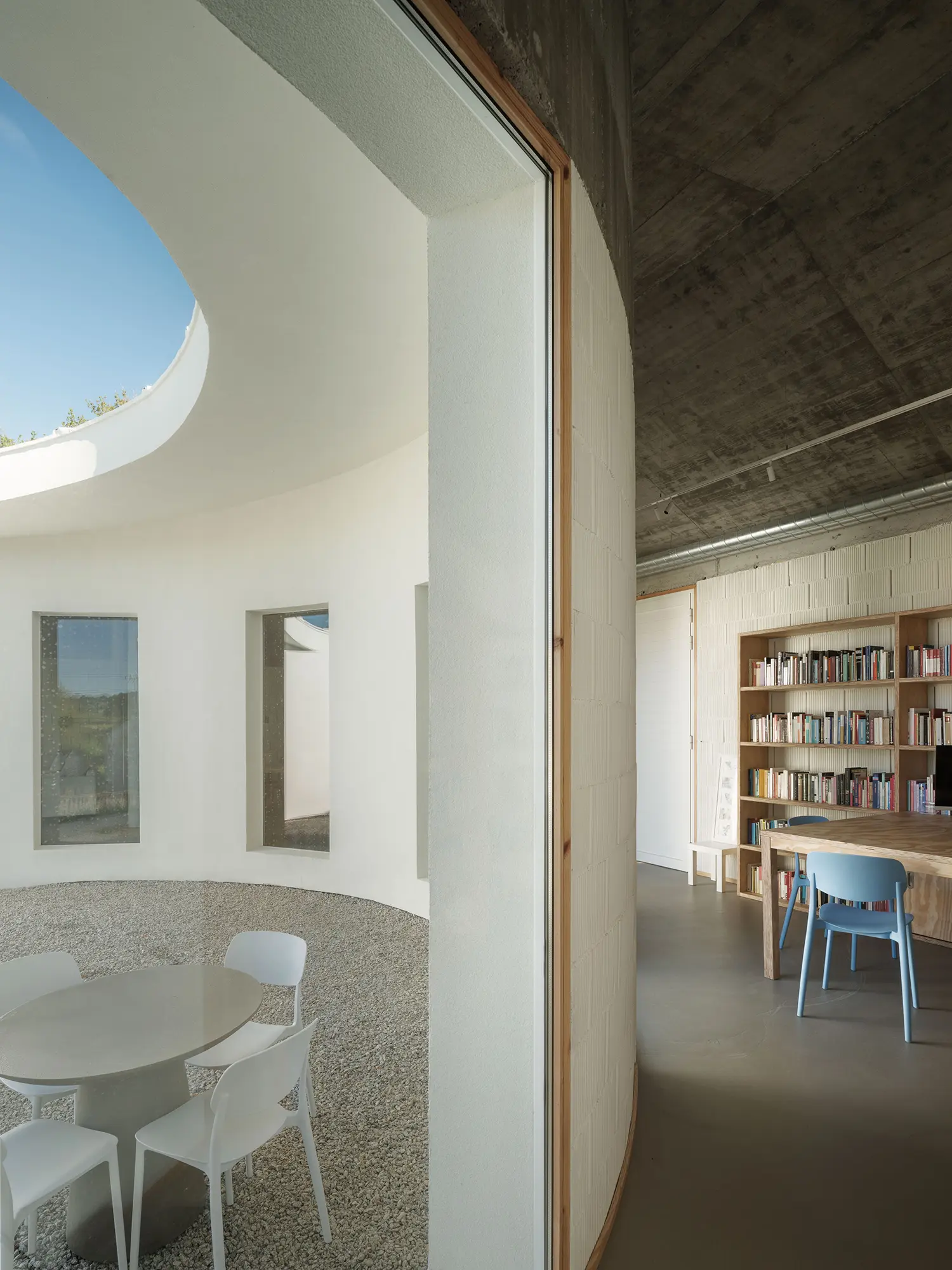 Cecebre House Sinaldaba Galicia threshold courtyard interior library plywood shelving oculus