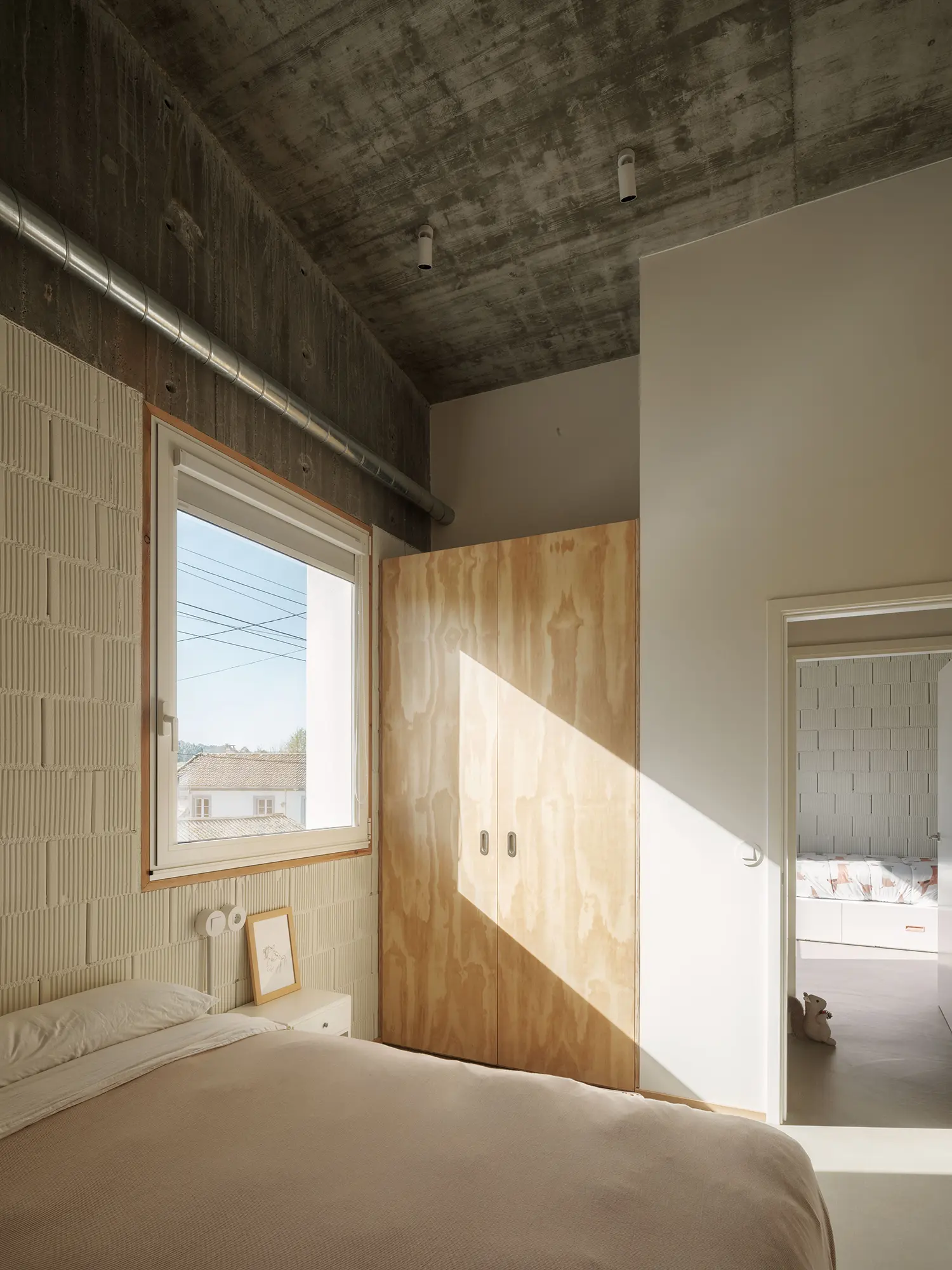 Cecebre House Sinaldaba Galicia bedroom plywood wardrobe cellular block wall south window