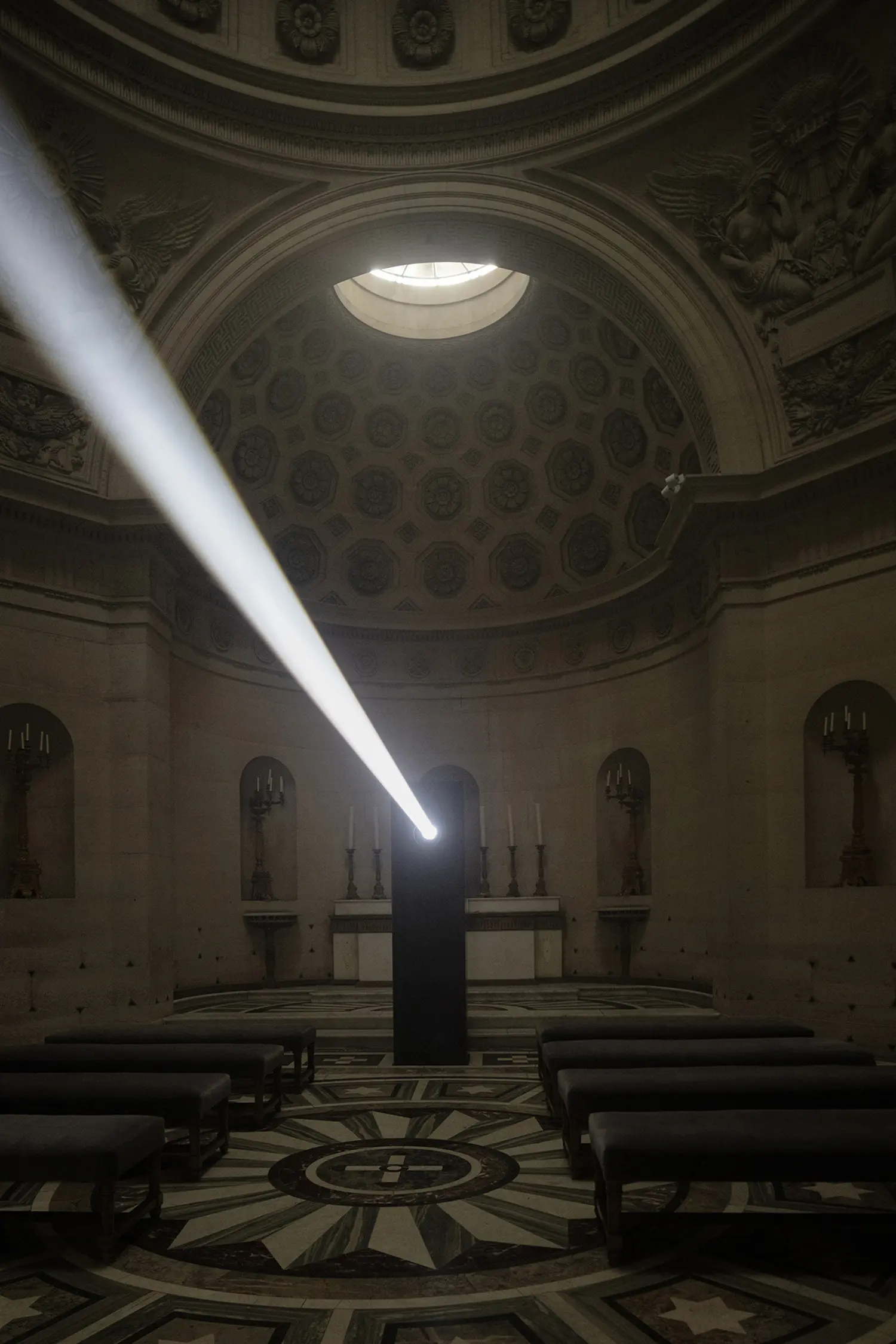 Threshold Emilio Ferro, diagonal white light beam emerging from black metal structure, neoclassical interior Chapelle Expiatoire Paris 2026