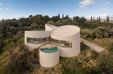 House in Las Rozas by Fran Silvestre Arquitectos, aerial view of five cylindrical volumes on hillside with pool