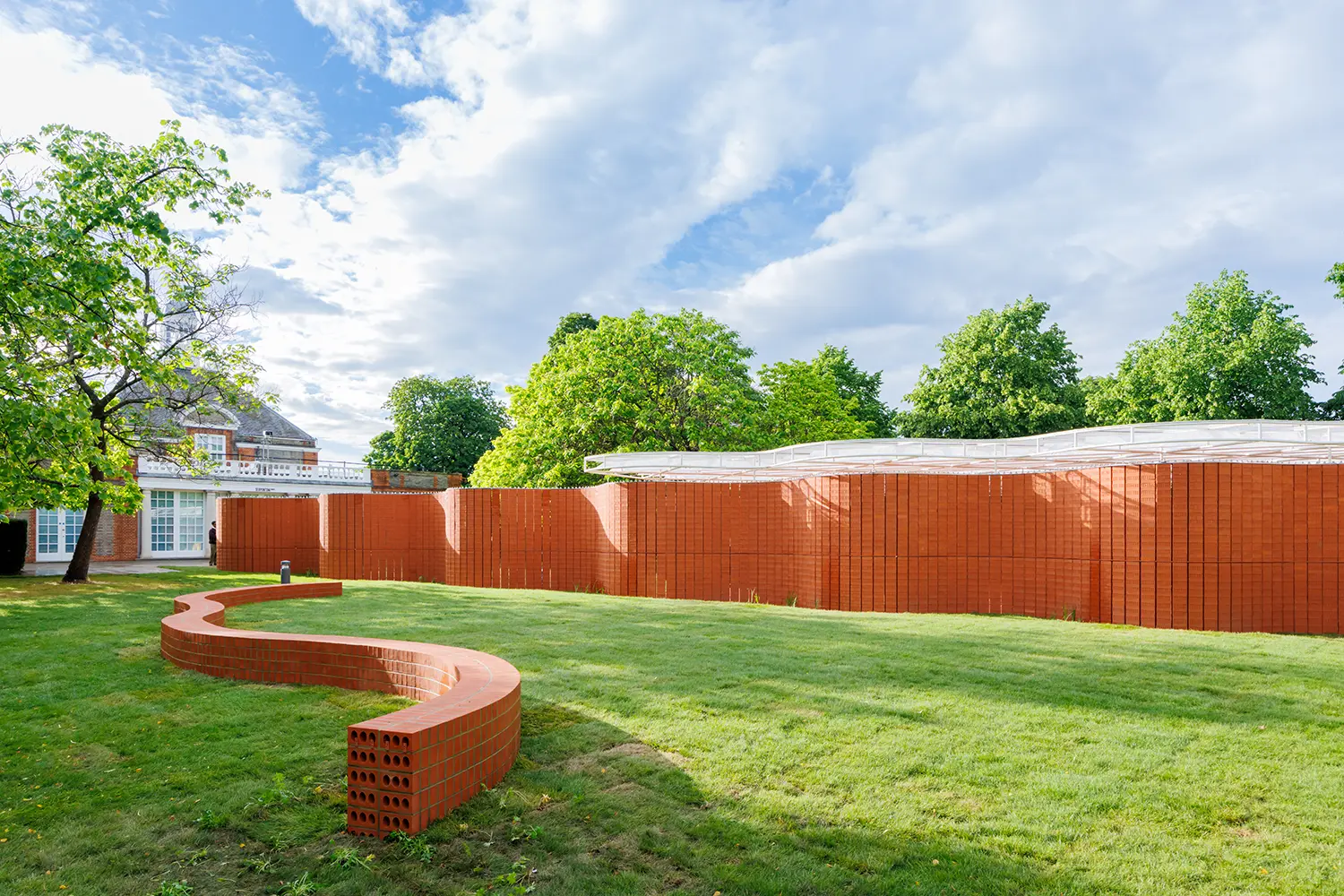 Serpentine Pavilion 2026 by LANZA atelier exterior view serpentine bench brick wall Kensington Gardens London
