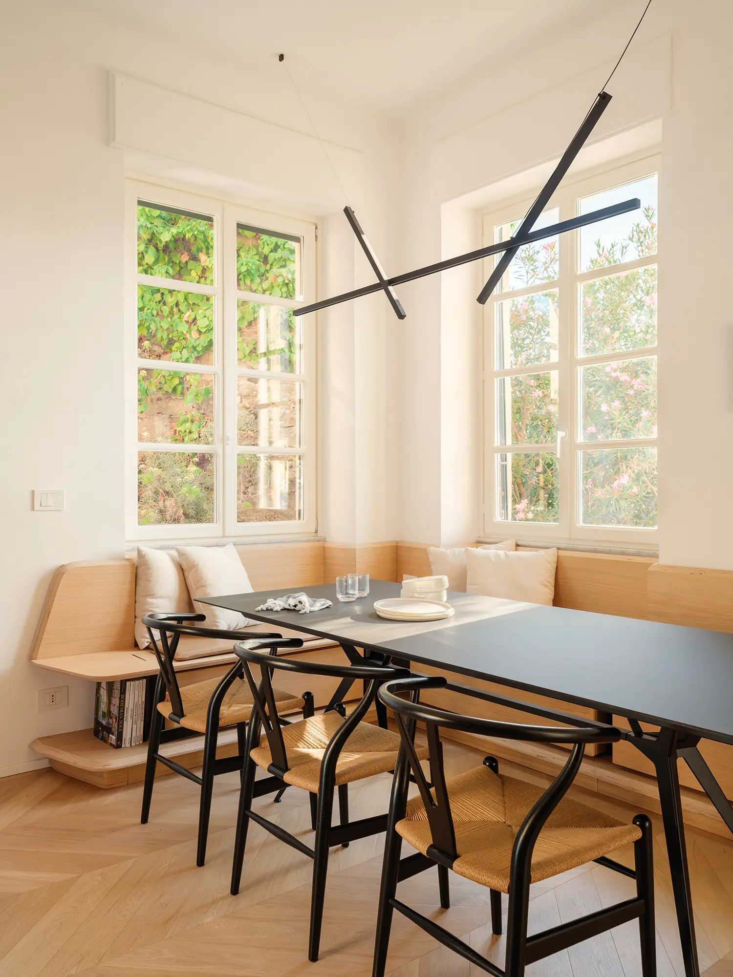 llabb Surf House Levanto dining area oak bench Carl Hansen CH24 Extendo Balance table Luceplan Across pendant 3.2m ceiling