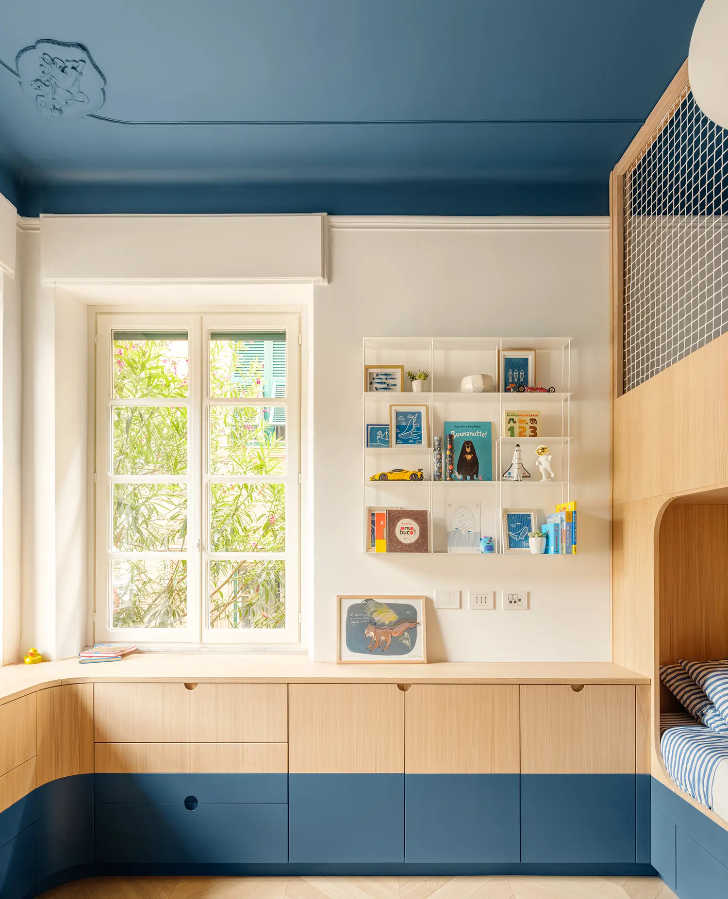 llabb Surf House Levanto children's bedroom deep blue painted ceiling oak millwork storage curved bunk rope net Kriptonite shelf