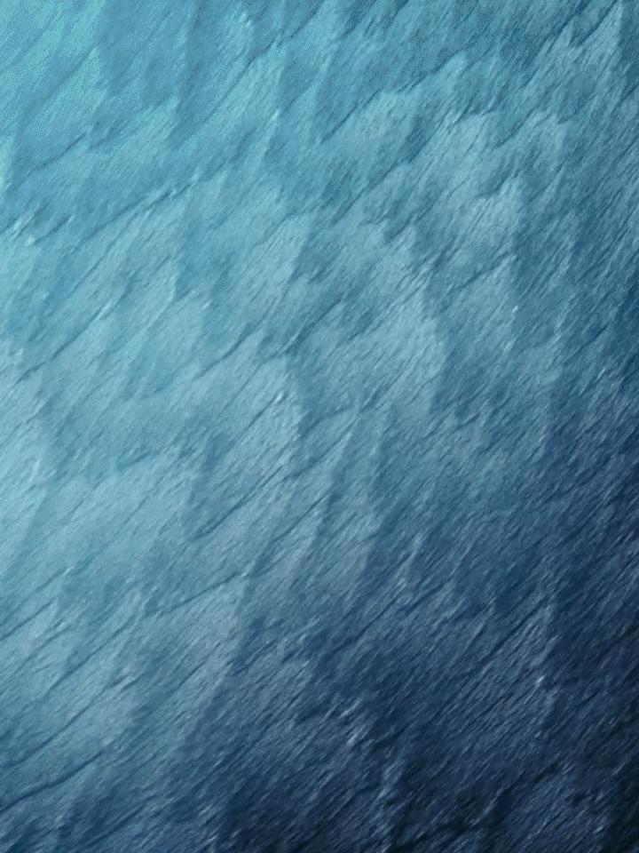 Close-up of water cascading down a blue textured surface at Louis Vuitton Men's SS27, Cité Internationale Universitaire de Paris
