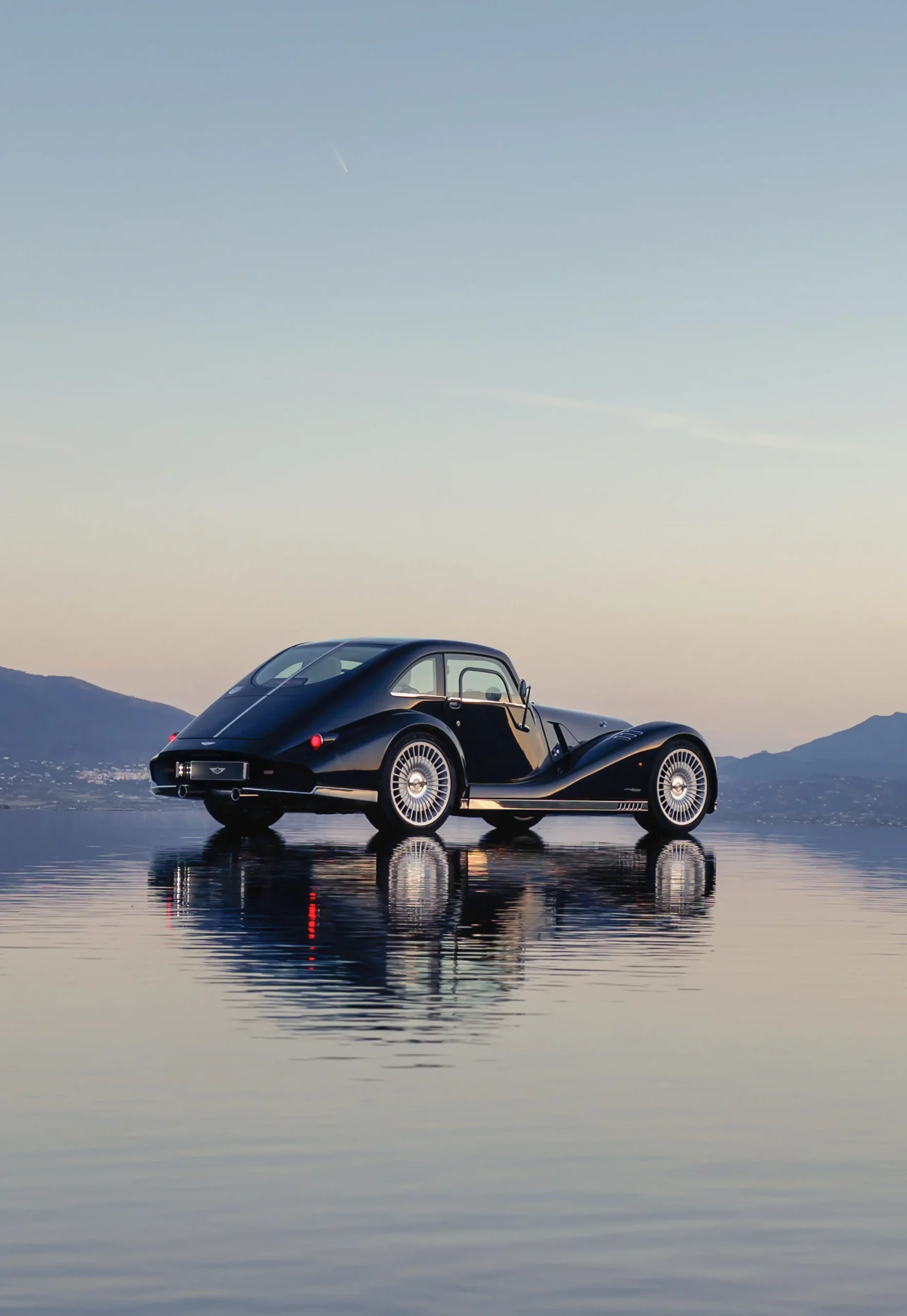 Morgan Midsummer Coupé Pininfarina coachbuilt rear three-quarter lake reflection dusk