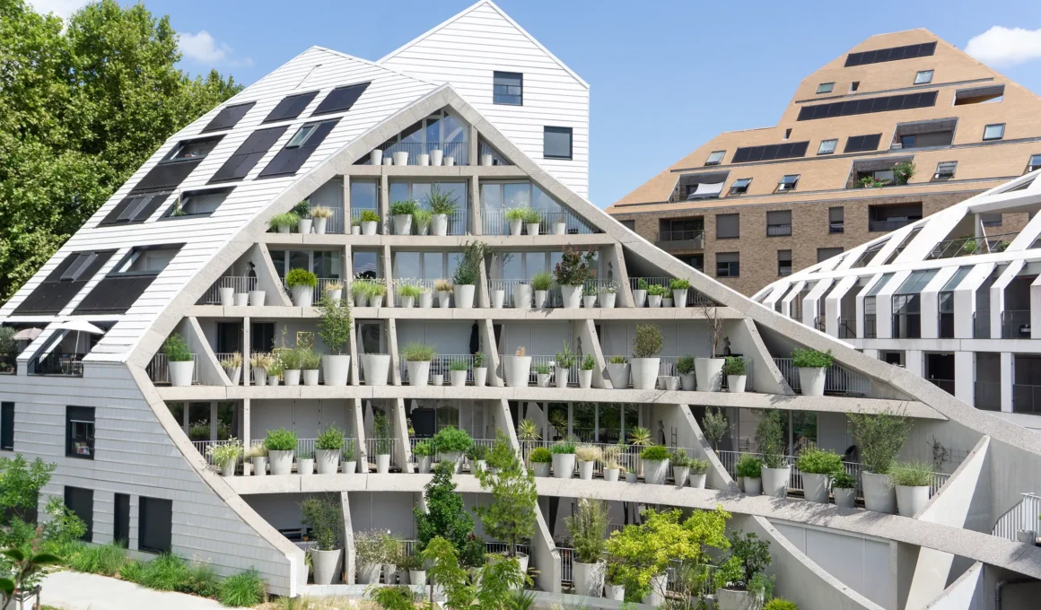 MVRDV La Vallée Verte Bordeaux, courtyard facade with angled concrete structure, stacked white plant pots multiple levels, suncut roofline geometry