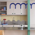 Not a Studio Monterols Barcelona kitchen CUBRO fronts steel countertop WAVES backsplash white mosaic tile green pillar