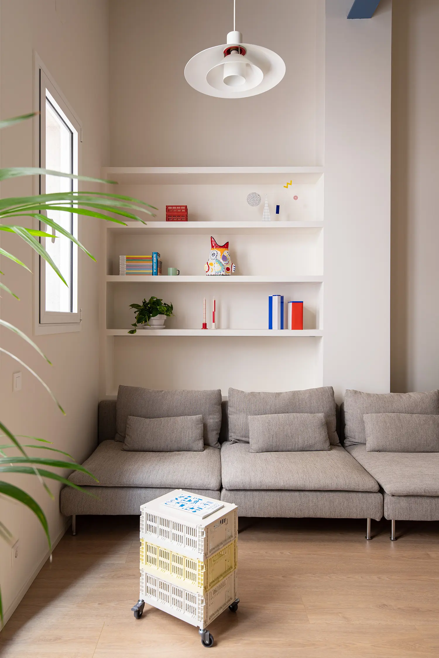 Not a Studio Monterols Barcelona living area built-in shelving vintage pendant lamp HAY crate side table on wheels