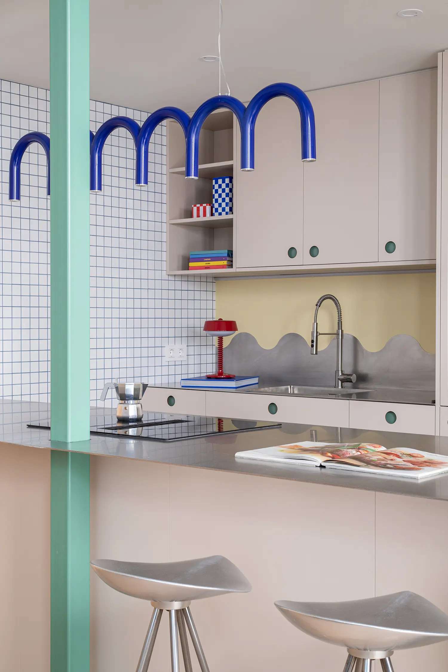 Not a Studio Monterols Barcelona kitchen island CUBRO fronts steel countertop blue arch pendants green structural pillar