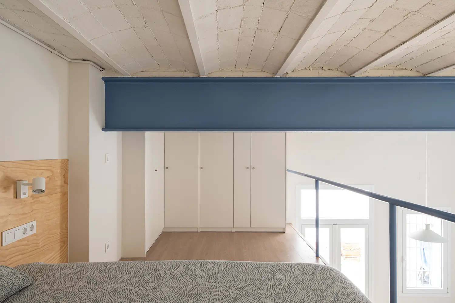 Not a Studio Monterols Barcelona mezzanine bedroom blue iron beam IKEA PAX wardrobes Catalan vault laminate floor